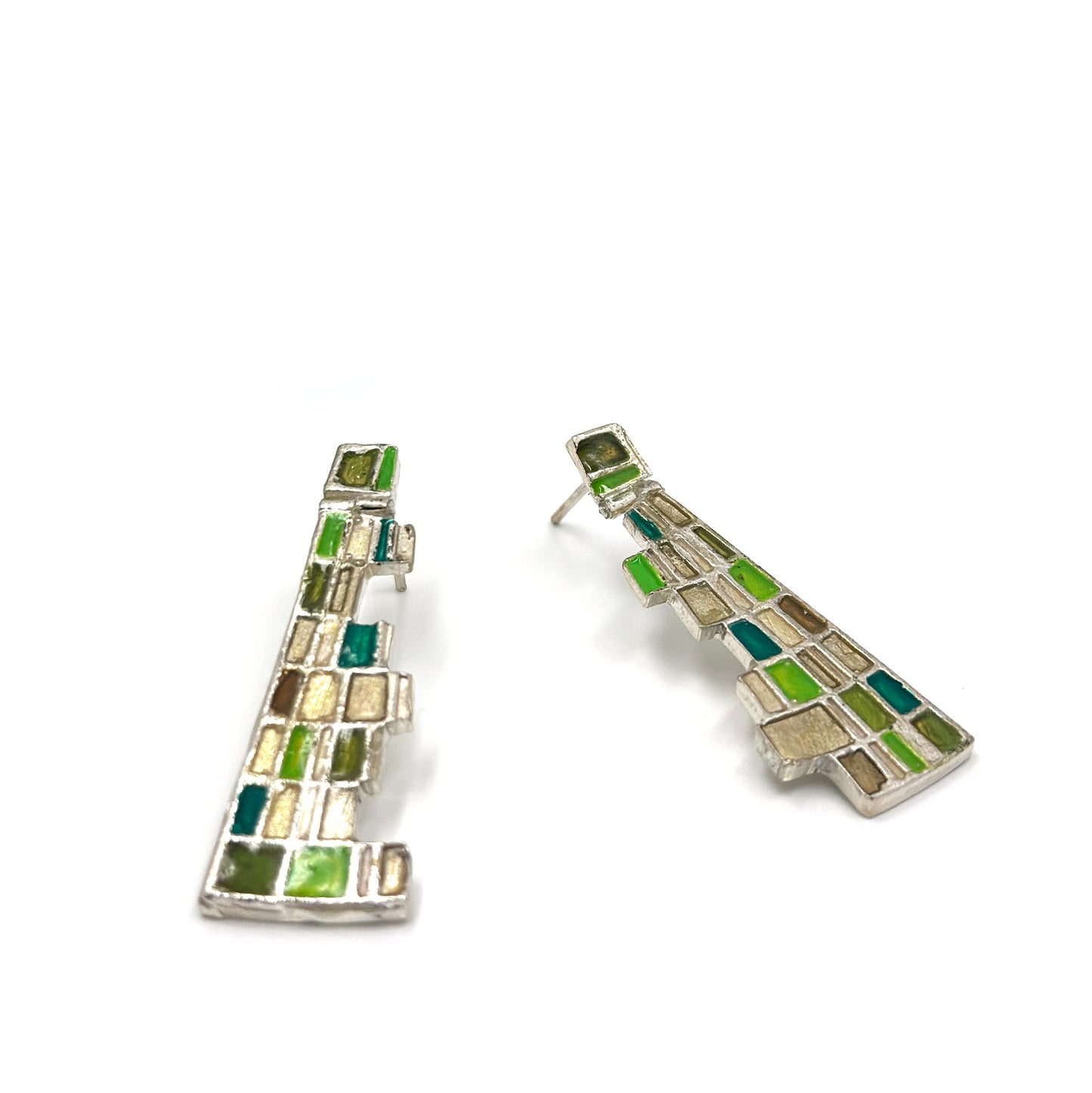 The Klimt Earrings by FR | Art Jewellery feature geometric building-inspired shapes in enamel-painted sterling silver, with blue, turquoise, gold, and white inlays. Displayed on a white background.