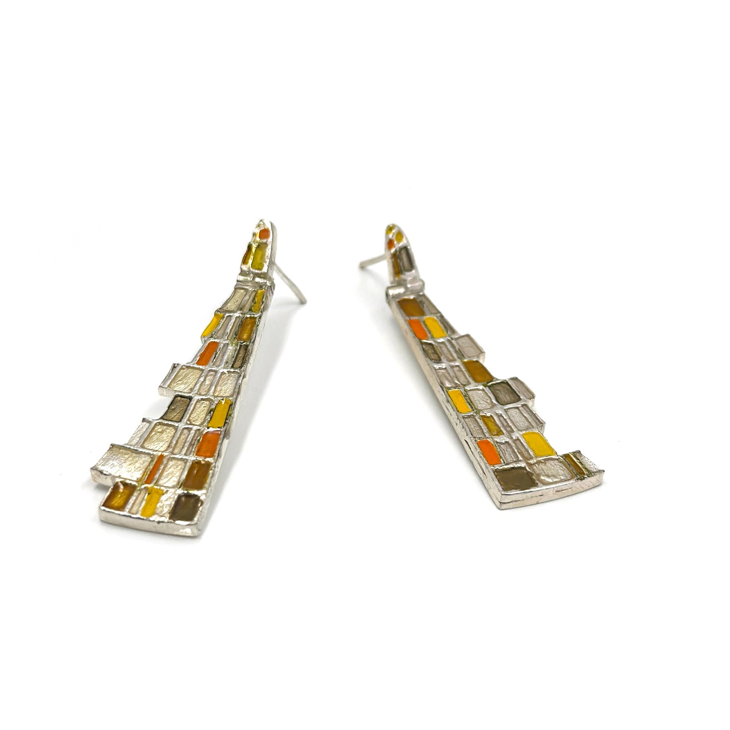 The Klimt Earrings by FR | Art Jewellery feature geometric building-inspired shapes in enamel-painted sterling silver, with blue, turquoise, gold, and white inlays. Displayed on a white background.