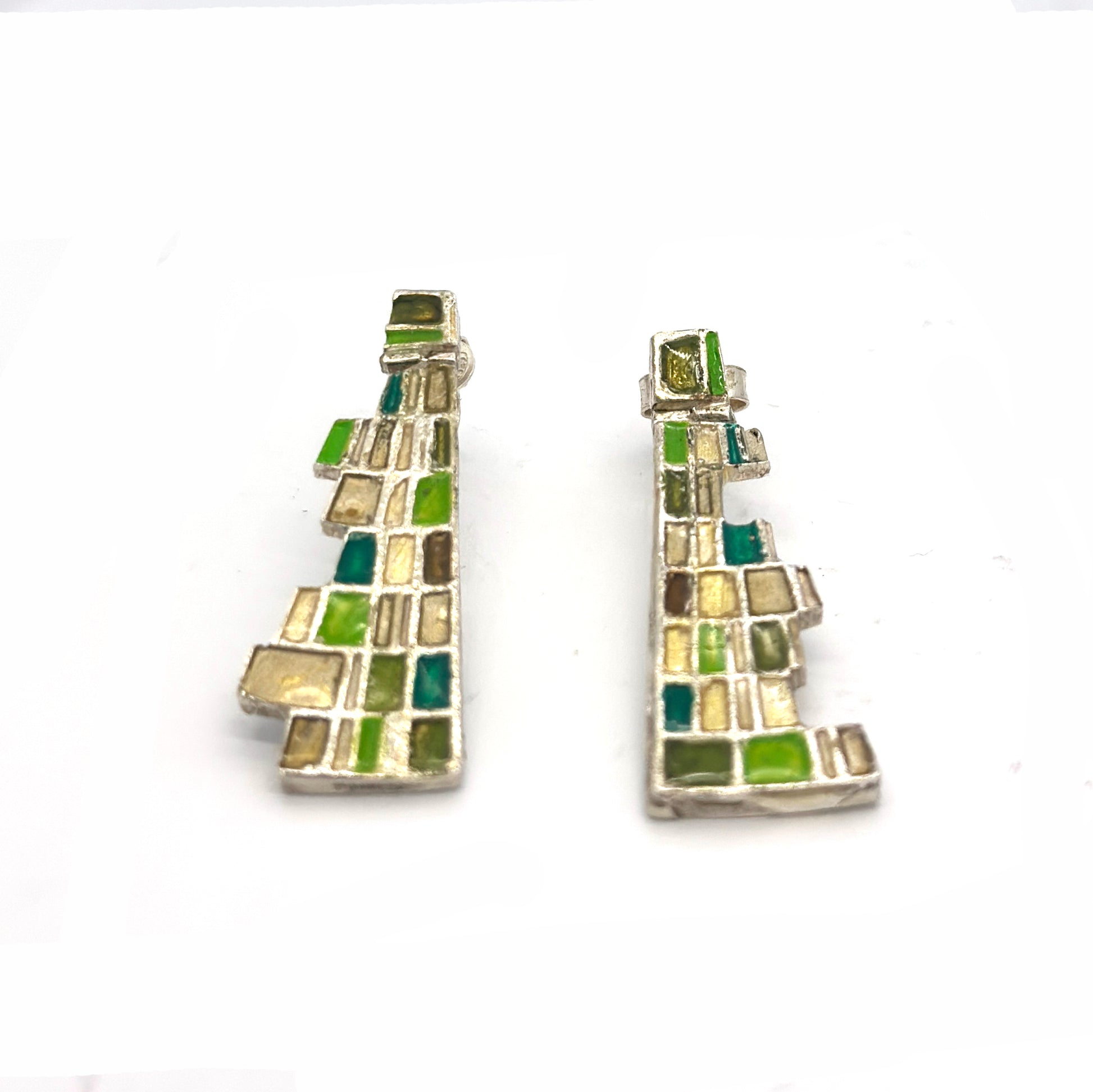 The Klimt Earrings by FR | Art Jewellery feature geometric building-inspired shapes in enamel-painted sterling silver, with blue, turquoise, gold, and white inlays. Displayed on a white background.