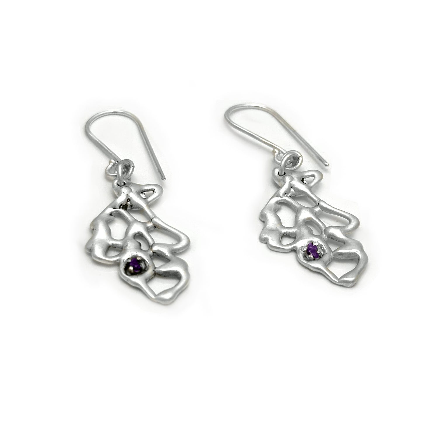 A pair of sterling silver Leaf Earrings by FR | Art Jewellery, showcasing an abstract, organic design with a small, round purple gemstone at the center. These earrings are part of the Blossom series from the Inspired by Nature Collection and feature hook clasps for easy wearing.