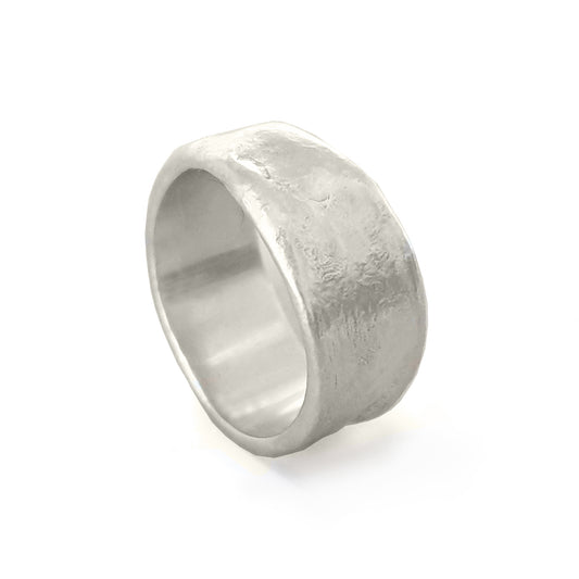 The Melted Ring by FR | Art Jewellery, featuring a rugged, textured surface and a slightly irregular, wide band, sits against a white background. The matte finish of the silver ring enhances its unique, handcrafted design characteristic of Handmade Jewellery.