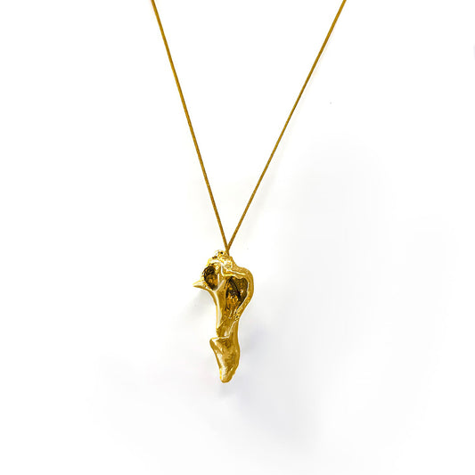 The Nucleous Necklace by FR | Art Jewellery boasts a distinct, abstract pendant inspired by organic, freeform shapes. Expertly crafted in the tradition of handmade jewellery, the pendant hangs gracefully from a delicate gold chain. Both the pendant and chain have a polished, shiny finish and are beautifully displayed against a plain white background.