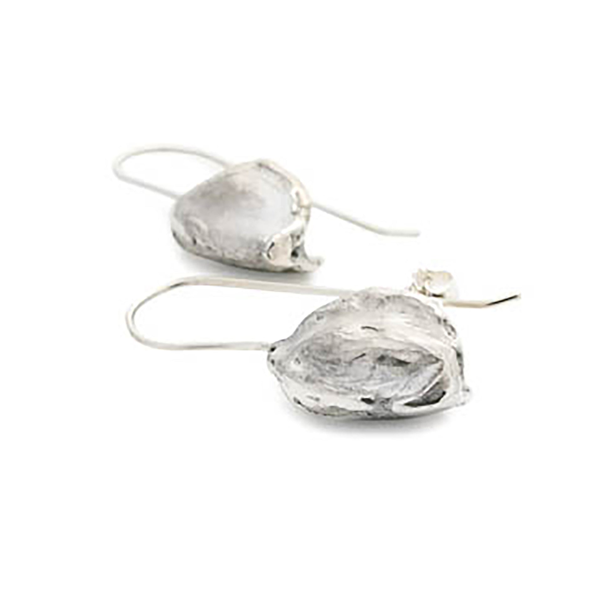 These Nut earrings from FR | Art Jewellery feature unique, organic shapes that resemble seeds or pods. As part of our handmade jewelry collection, each earring is attached to a simple wire hook for easy wearing. The shiny silver surface boasts a reflective finish with subtle textural details.