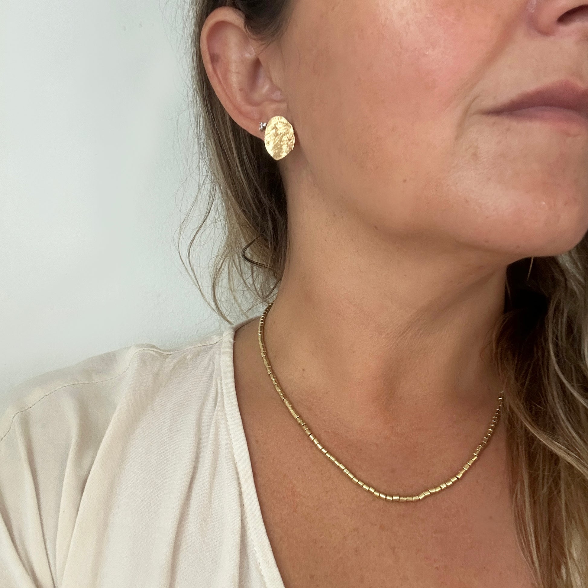 Ocean Whisper Sterling Silver Earrings by FR | Art Jewellery feature two rough, metallic silver discs with textured surfaces, capturing raw coastal beauty. From the Handmade Shell & Coastal Jewellery collection. Shown on a white background.