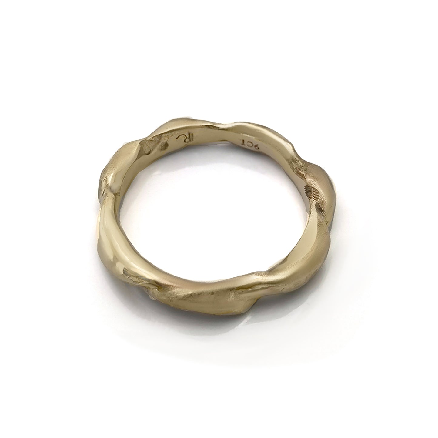 The Ocean Band by FR | Art Jewellery is a gold ring featuring a distinctive wavy texture that wraps around the band. With its polished finish and handcrafted appearance, the ring exudes an organic and artistic vibe. Subtle engravings adorn the inside of the band. This exquisite piece of handmade jewellery is showcased against a white background.
