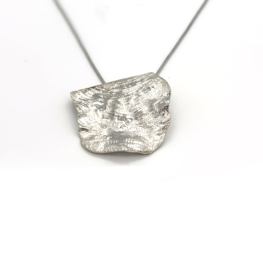 Handmade sterling silver organic pendant necklace with sculptural textured surface by FR Art Jewellery.