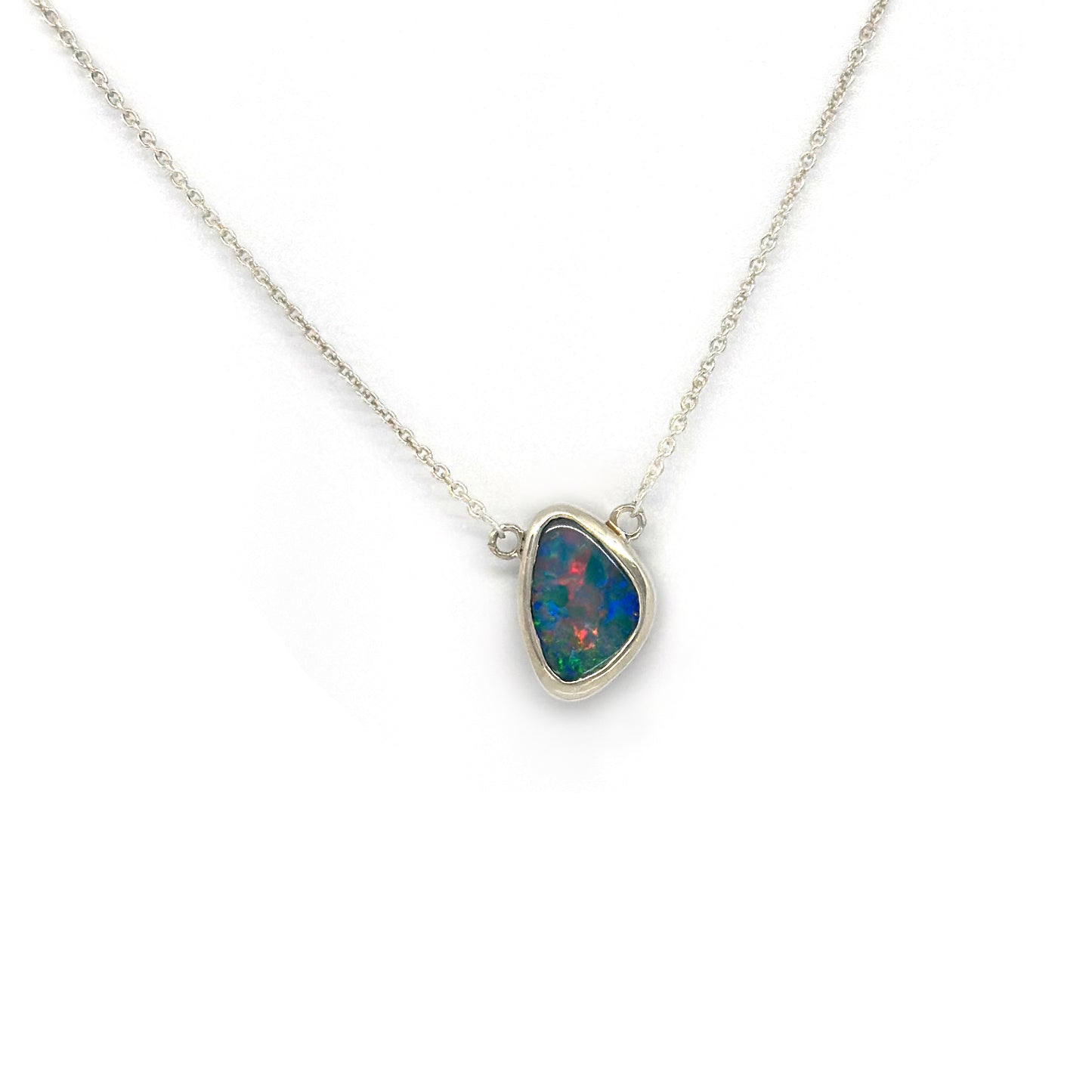 Handmade sterling silver necklace featuring a freeform Australian opal with vibrant blue and red tones, designed by FR Art Jewellery.