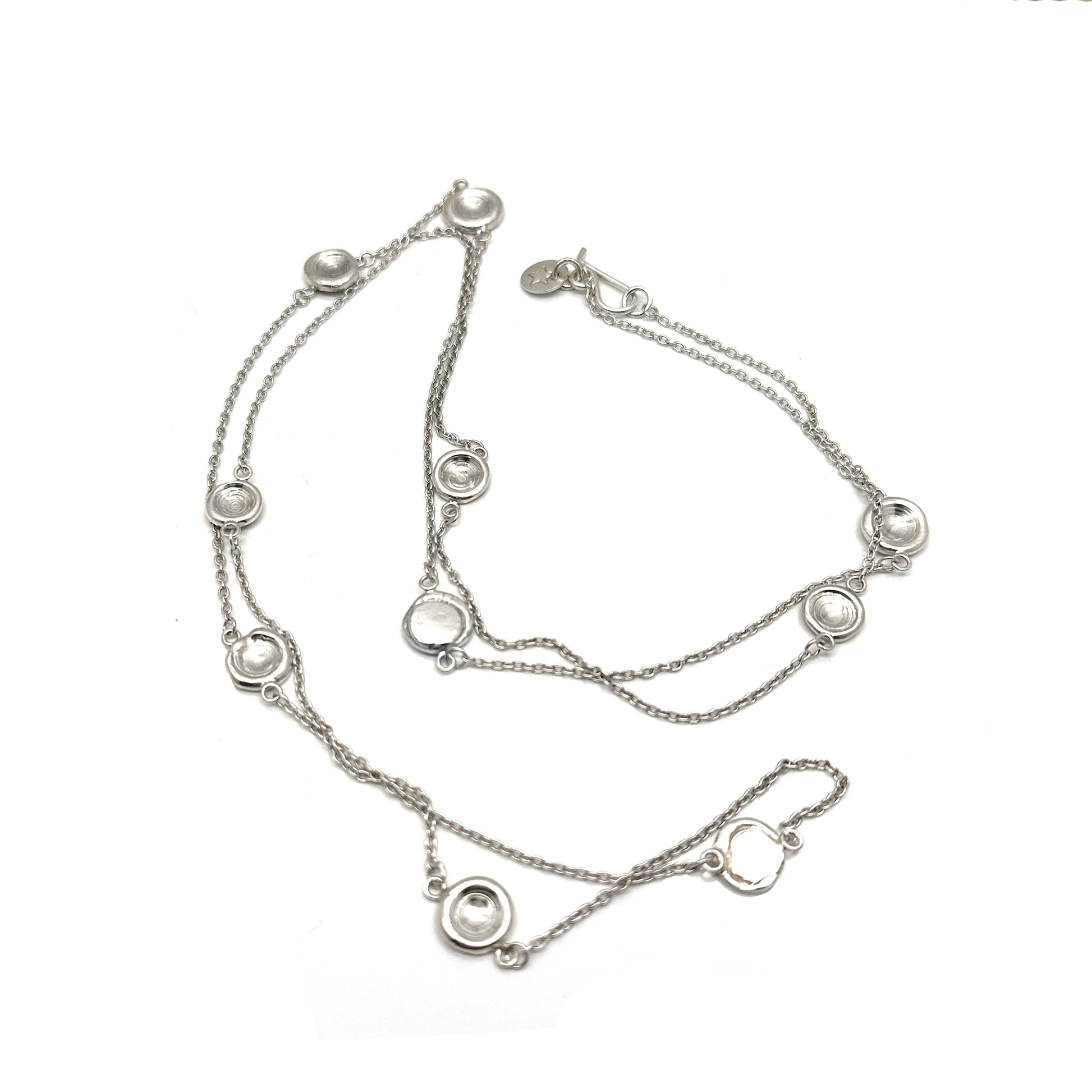 The Pebble Sterling Silver Necklace by FR | Art Jewellery is a handmade contemporary piece featuring evenly spaced circular pendants with clear stones, shown on a white background—crafted in Australia with minimalist elegance.