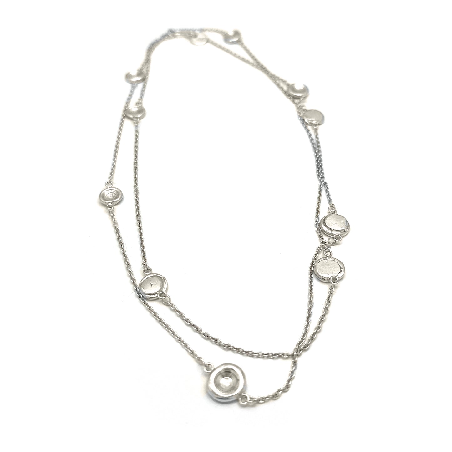 The Pebble Sterling Silver Necklace by FR | Art Jewellery is a handmade contemporary piece featuring evenly spaced circular pendants with clear stones, shown on a white background—crafted in Australia with minimalist elegance.