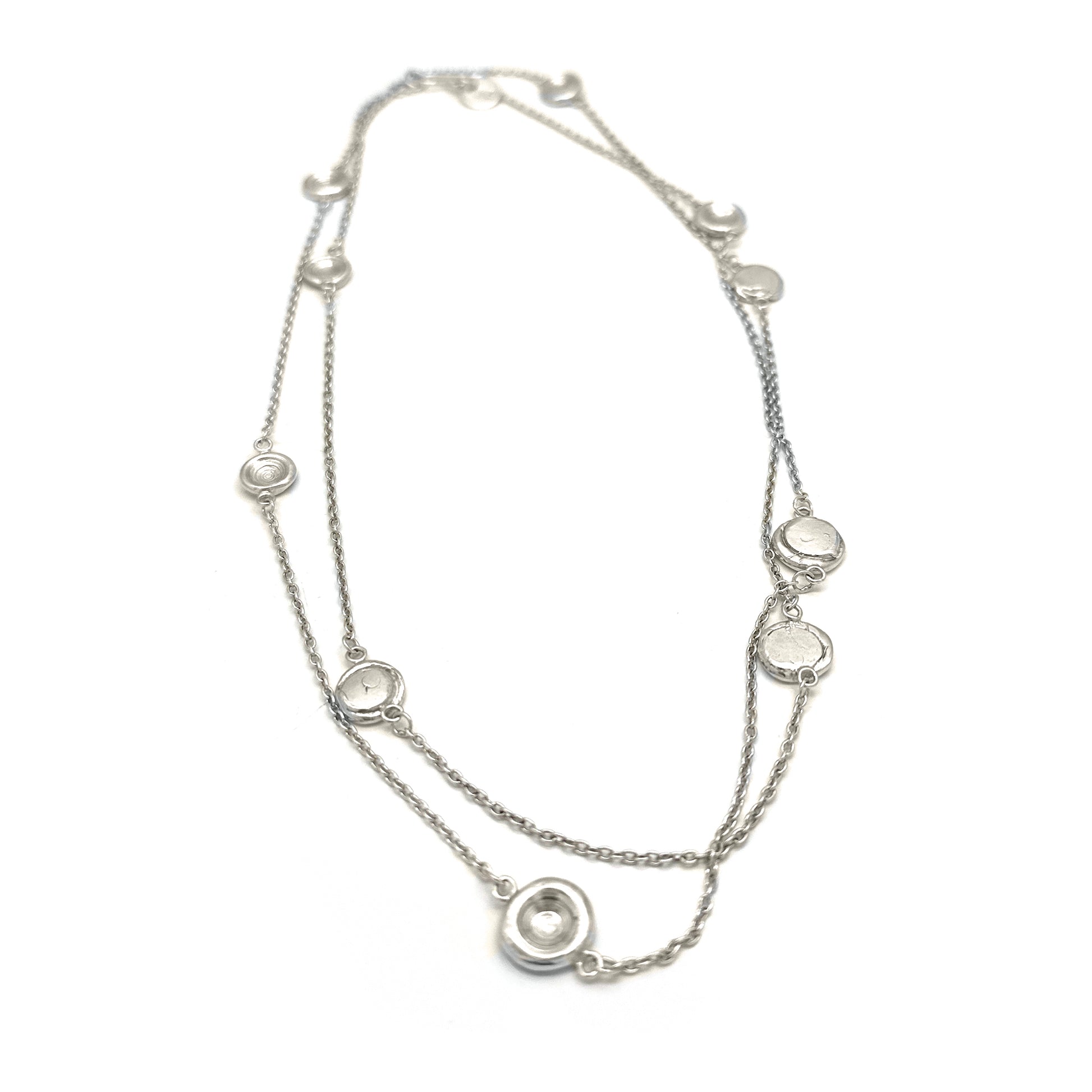 The Pebble Sterling Silver Necklace by FR | Art Jewellery is a handmade contemporary piece featuring evenly spaced circular pendants with clear stones, shown on a white background—crafted in Australia with minimalist elegance.