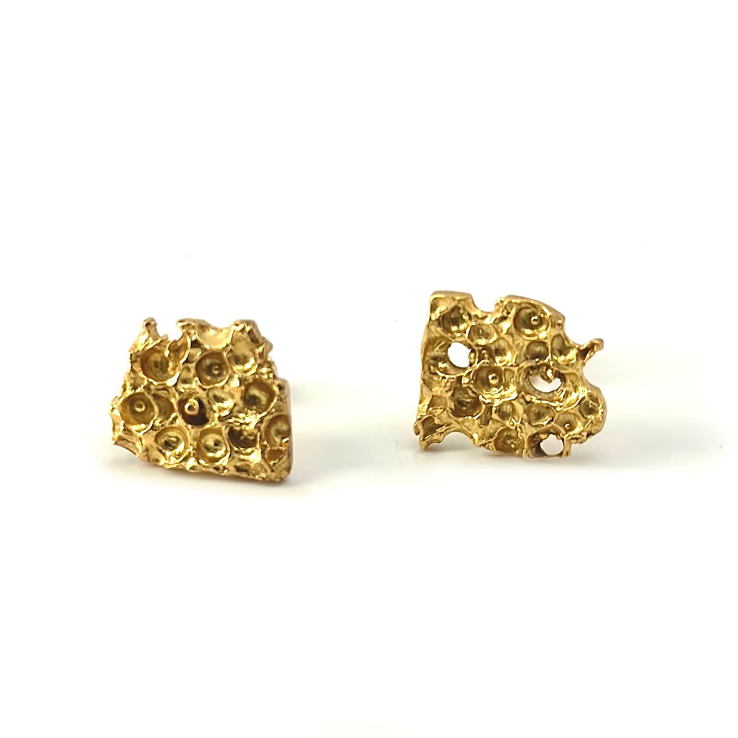 The Porocious Earrings by FR | Art Jewellery are a pair of small, gold-plated stud earrings featuring an abstract, textured design with multiple rounded indentations. This handmade jewellery is displayed against a plain white background, making it perfect for custom-made orders.