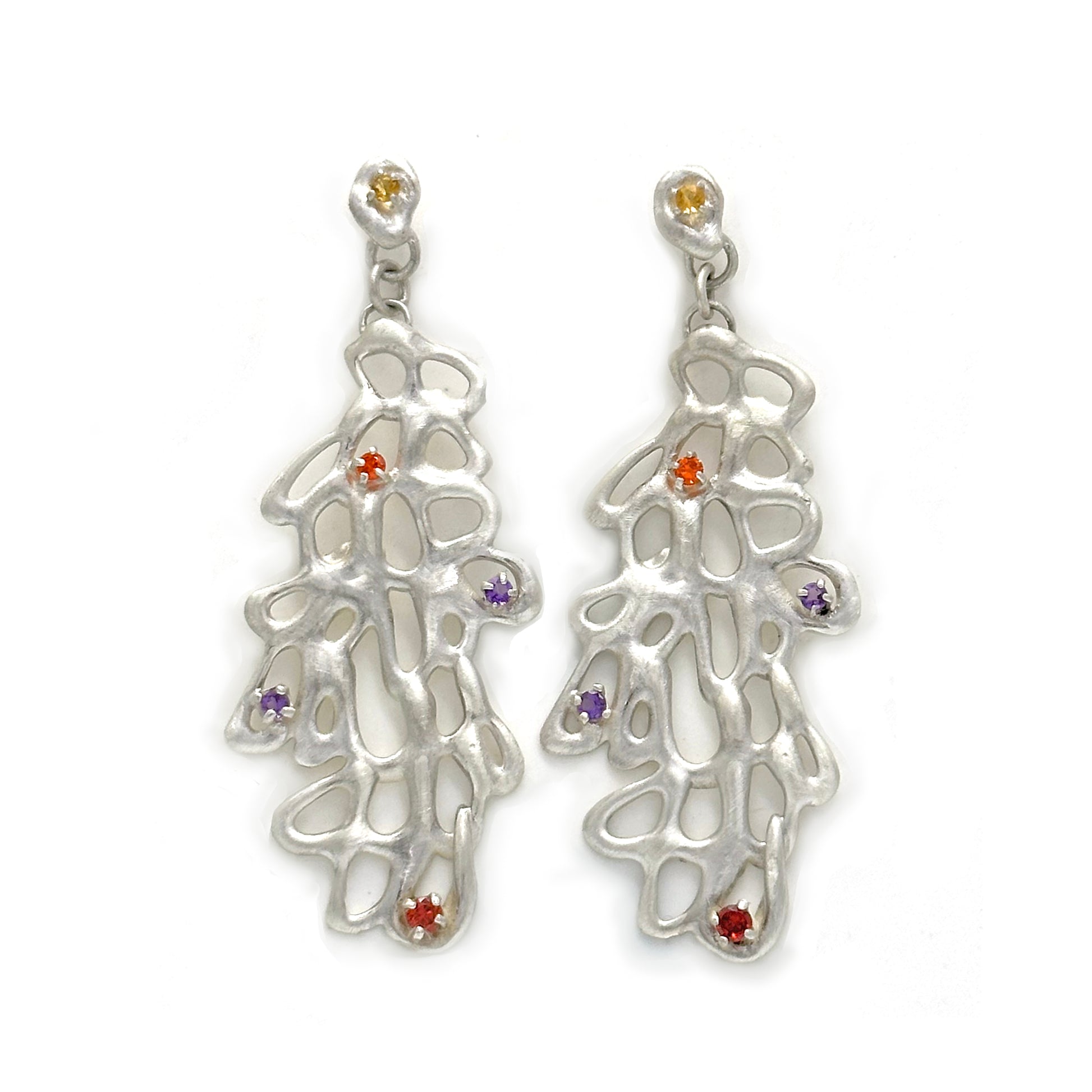 The Raceme Earrings by FR | Art Jewellery showcase an elaborate sterling silver design that mimics a branching, web-like structure. Each earring is embellished with small, vibrant gemstones in shades of orange, red, yellow, and purple. Part of the Blossom Series, these earrings have a delicate and artistic allure.