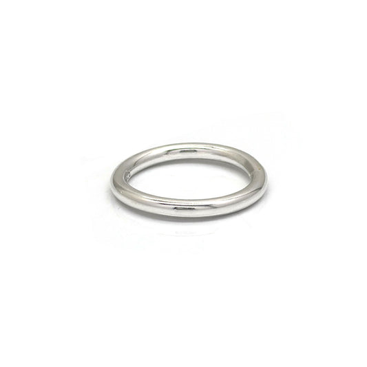 The Round Ring by FR | Art Jewellery is a simple, sleek silver wedding band featuring a smooth, polished finish. Its classic, timeless design boasts a rounded band without any additional embellishments or decorations. This handmade piece of jewellery is displayed against a plain white background.