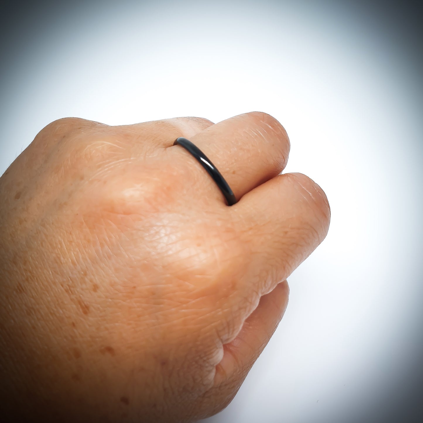 The Stainless Steel Black 2mm ring by FR | Art Jewellery is displayed upright against a plain white background, showcasing its simple and thin stacking design.