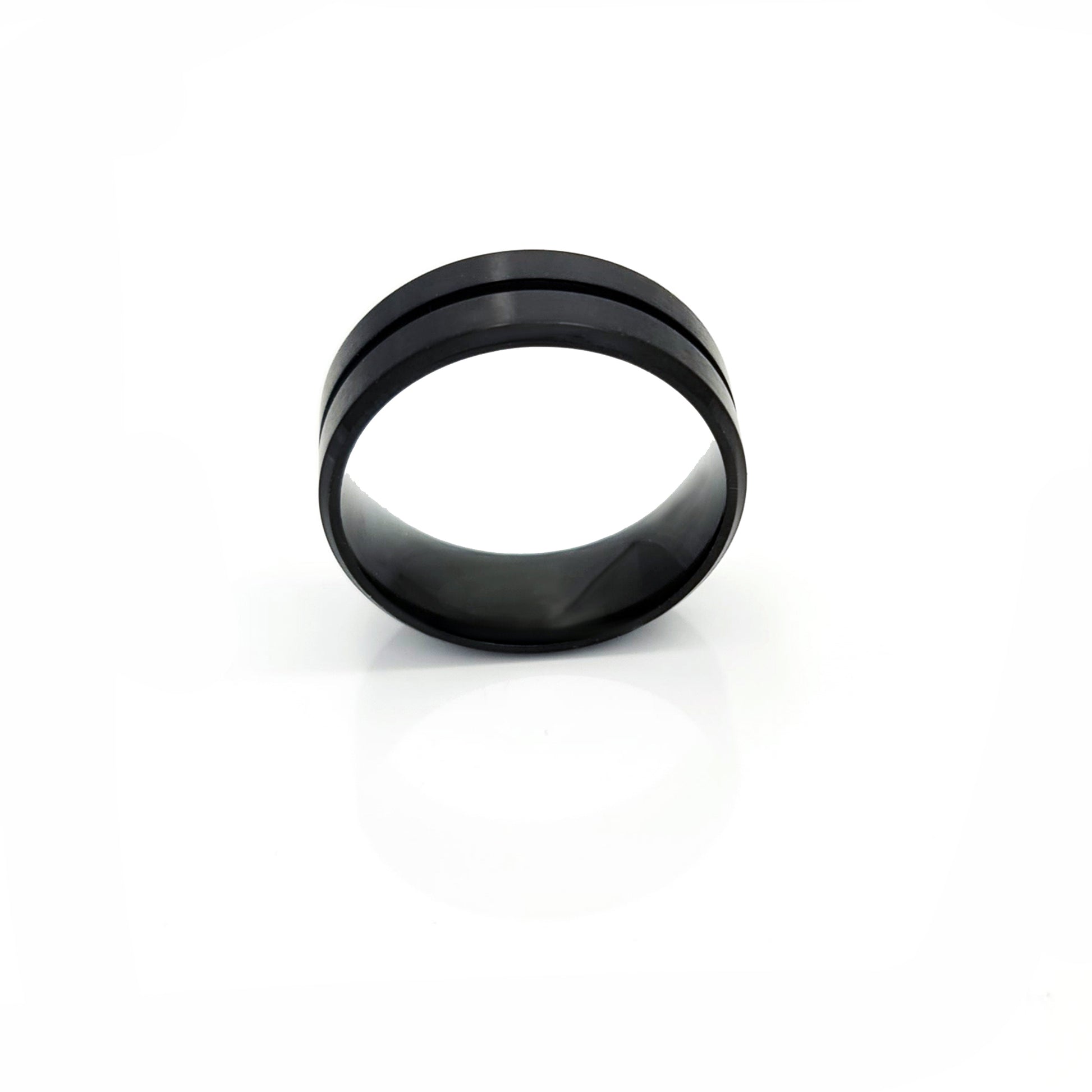 The FR | Art Jewellery Stainless Steel Line Middle ring is a contemporary matte black wedding band with a sleek single groove, showcased on a plain white background.