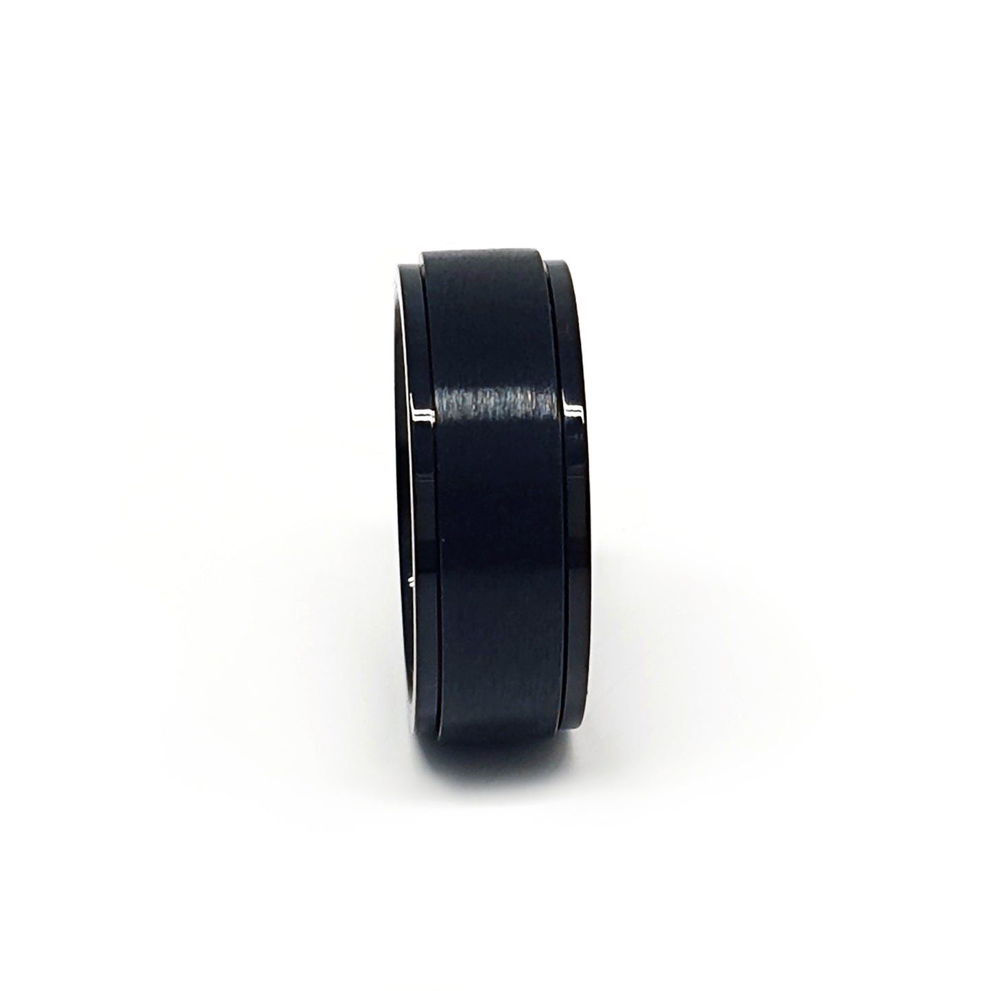 The FR | Art Jewellery Stainless Steel Rotatable Black ring features a sleek matte finish and minimalist design, offering a smooth comfort fit for daily wear. Displayed against a white background, it's modern and stylish.