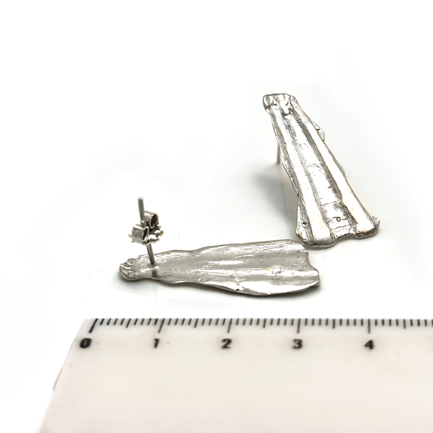 Sterling silver sculptural shell-textured earrings with elongated ridges, handmade by FR Art Jewellery two