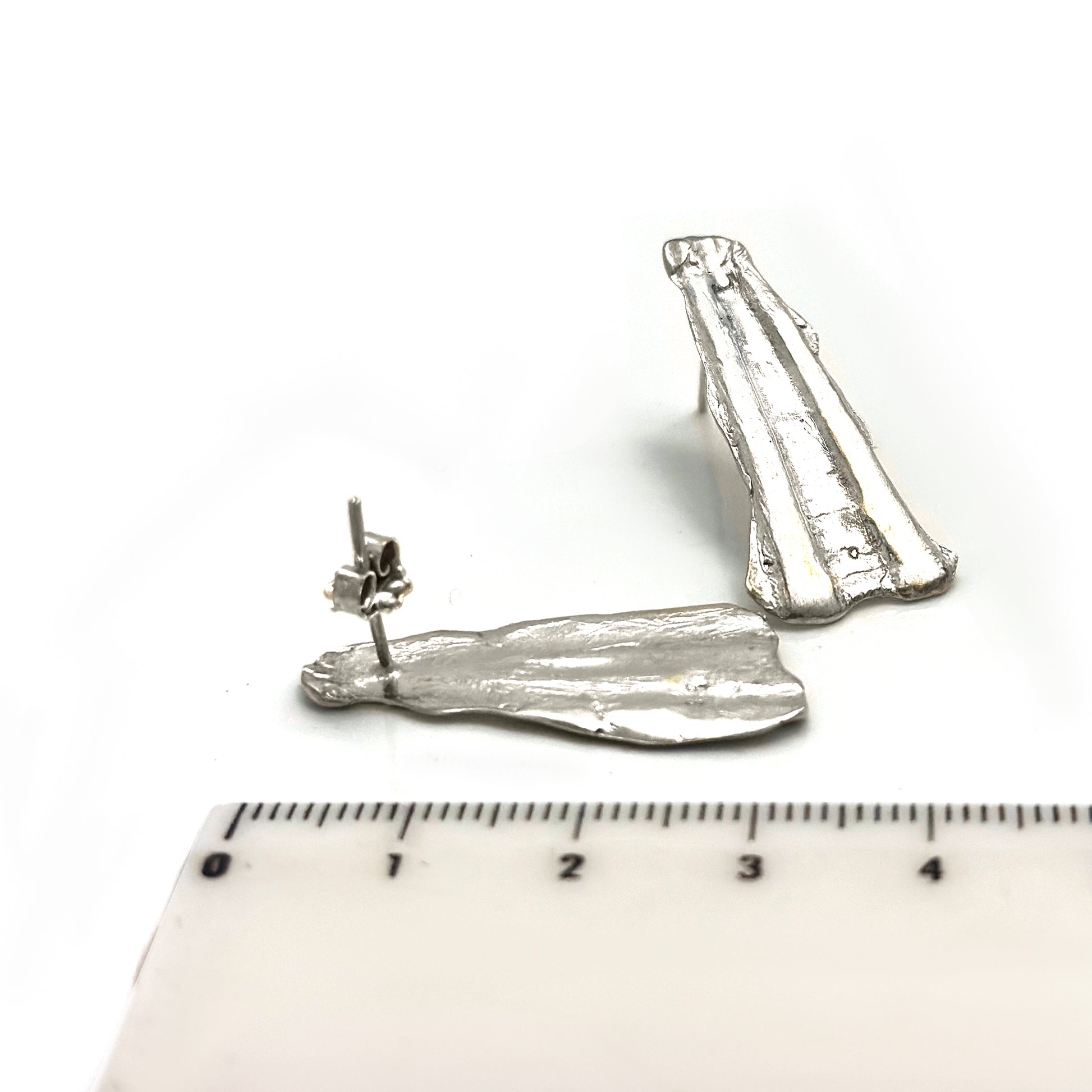 Sterling silver sculptural shell-textured earrings with elongated ridges, handmade by FR Art Jewellery two