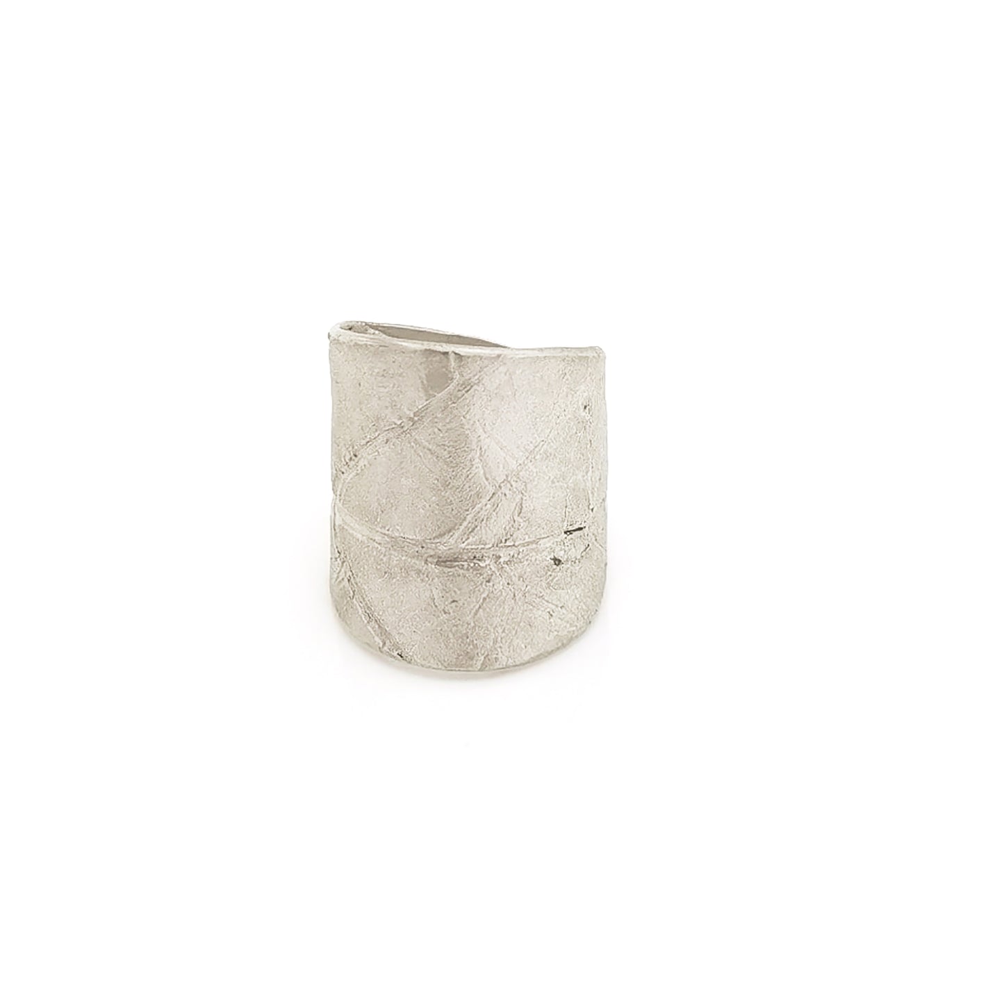 A wide, silver, adjustable "Silver Leaf Ring" by FR | Art Jewellery is placed on a plain white background. Part of the "Inspired by Nature Collection," the ring features subtle leaf patterns and has a textured, matte finish, giving it an organic and earthy appearance.