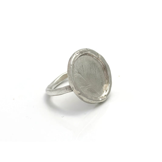 The Silver Leaf Impression Ring – Sterling Silver by FR | Art Jewellery features a wide, round flat top with subtle, nature-inspired engravings and a raised edge, beautifully showcased against a white background.