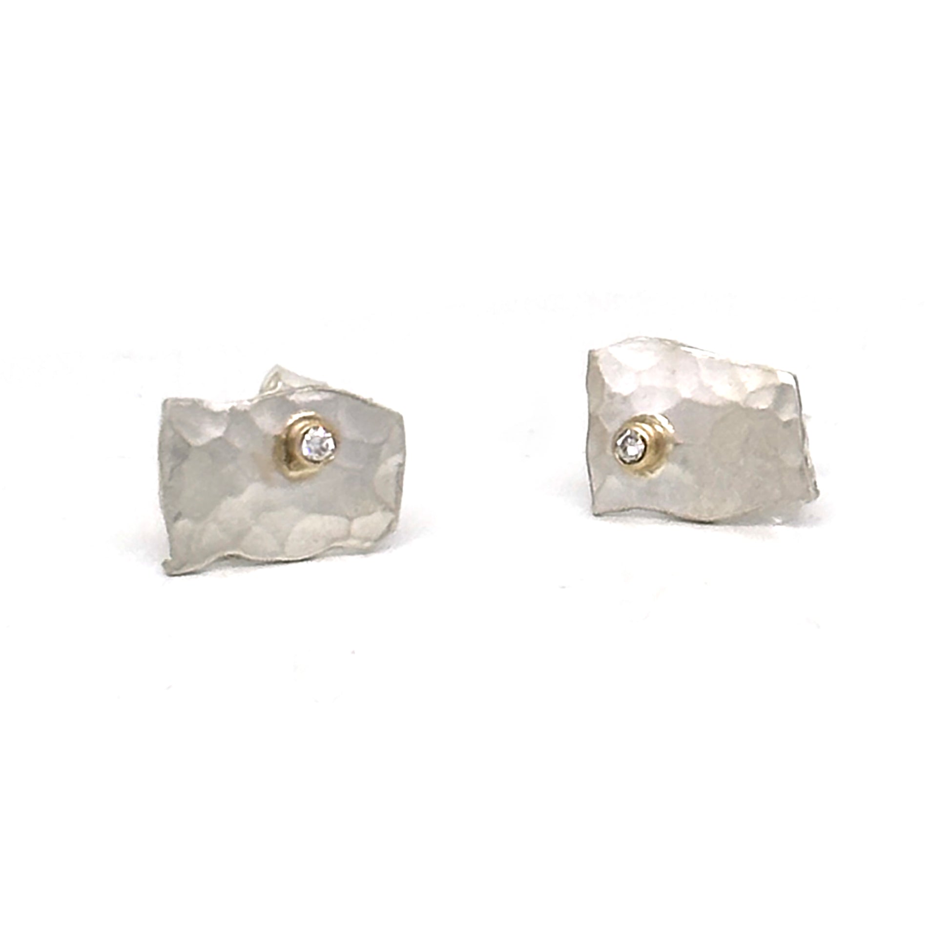 A pair of Small Shooting Star earrings by FR | Art Jewellery, featuring a gold-plated design with an uneven, hammered texture and a small, round diamond-like gem set in the center of each earring. The handmade jewelry is displayed against a plain white background.