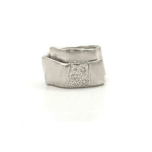 The Spiral Diamond Ring – Sterling Silver by FR | Art Jewellery features a modern geometric design with an angular band and a textured center set with sparkling stones—a handcrafted statement piece.