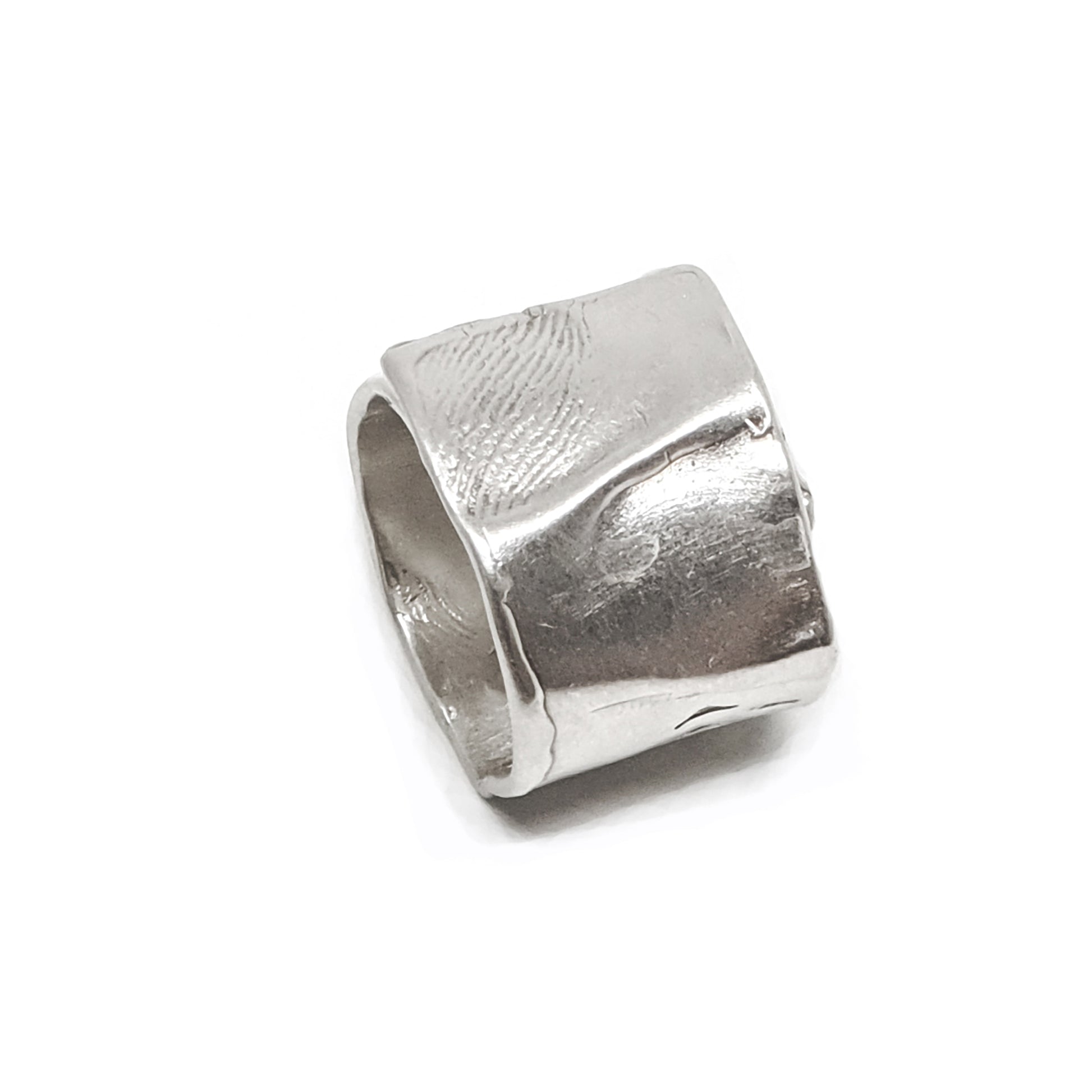 The Sterling Silver Spirel Ring by FR | Art Jewellery features a wide, oxidised band with a wavy textured surface and a visible fingerprint, giving this handcrafted piece an organic, one-of-a-kind look.