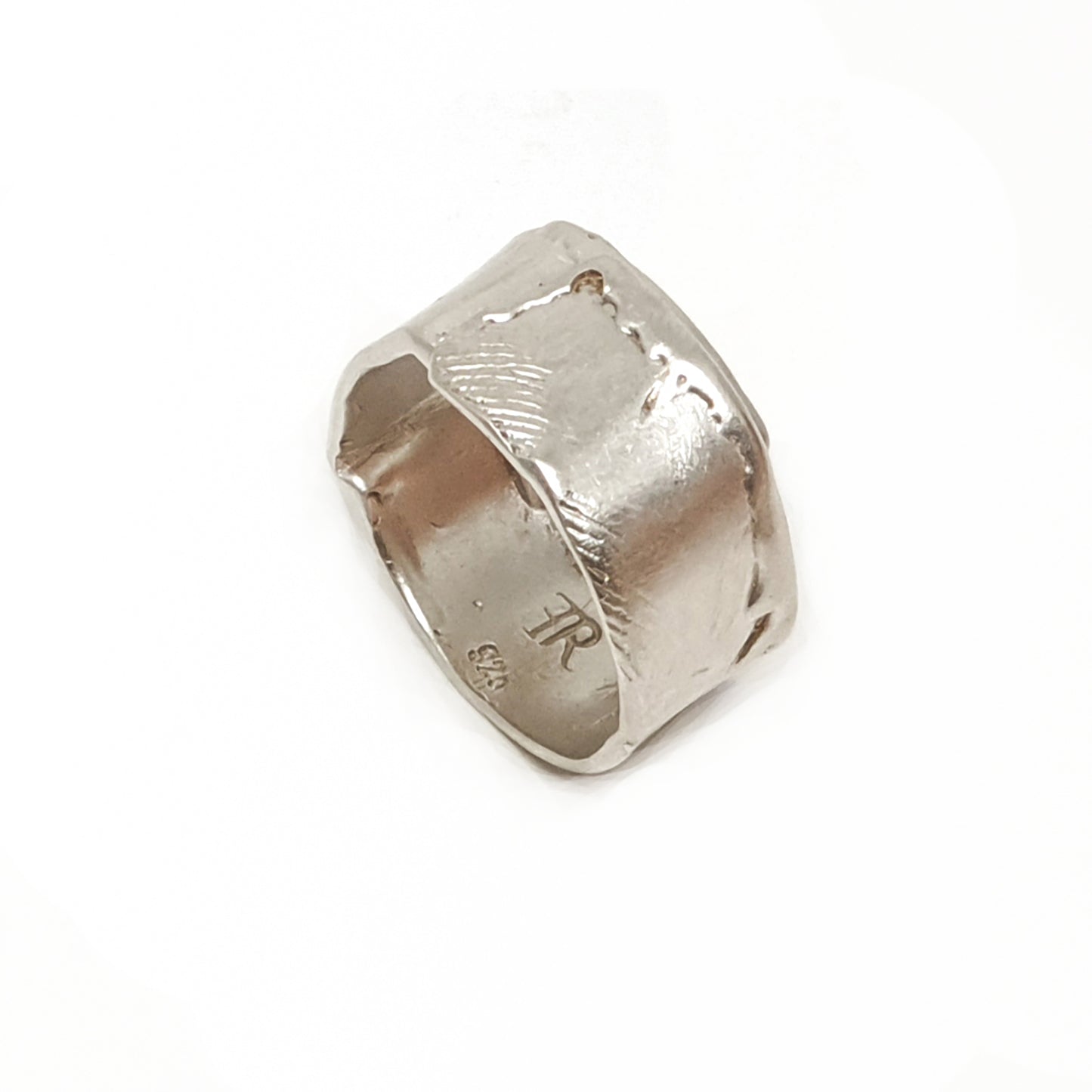 The Sterling Silver Spirel Ring by FR | Art Jewellery features a wide, oxidised band with a wavy textured surface and a visible fingerprint, giving this handcrafted piece an organic, one-of-a-kind look.