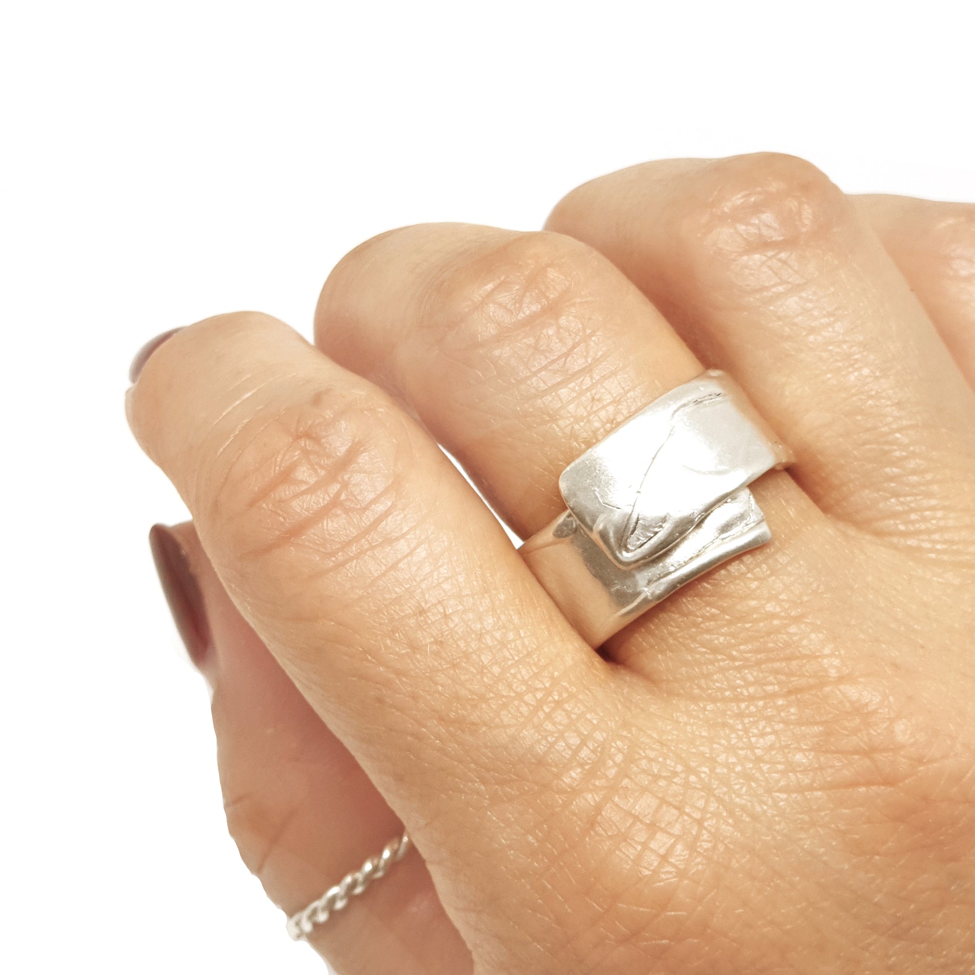 The Sterling Silver Spirel Ring by FR | Art Jewellery features a wide, oxidised band with a wavy textured surface and a visible fingerprint, giving this handcrafted piece an organic, one-of-a-kind look.