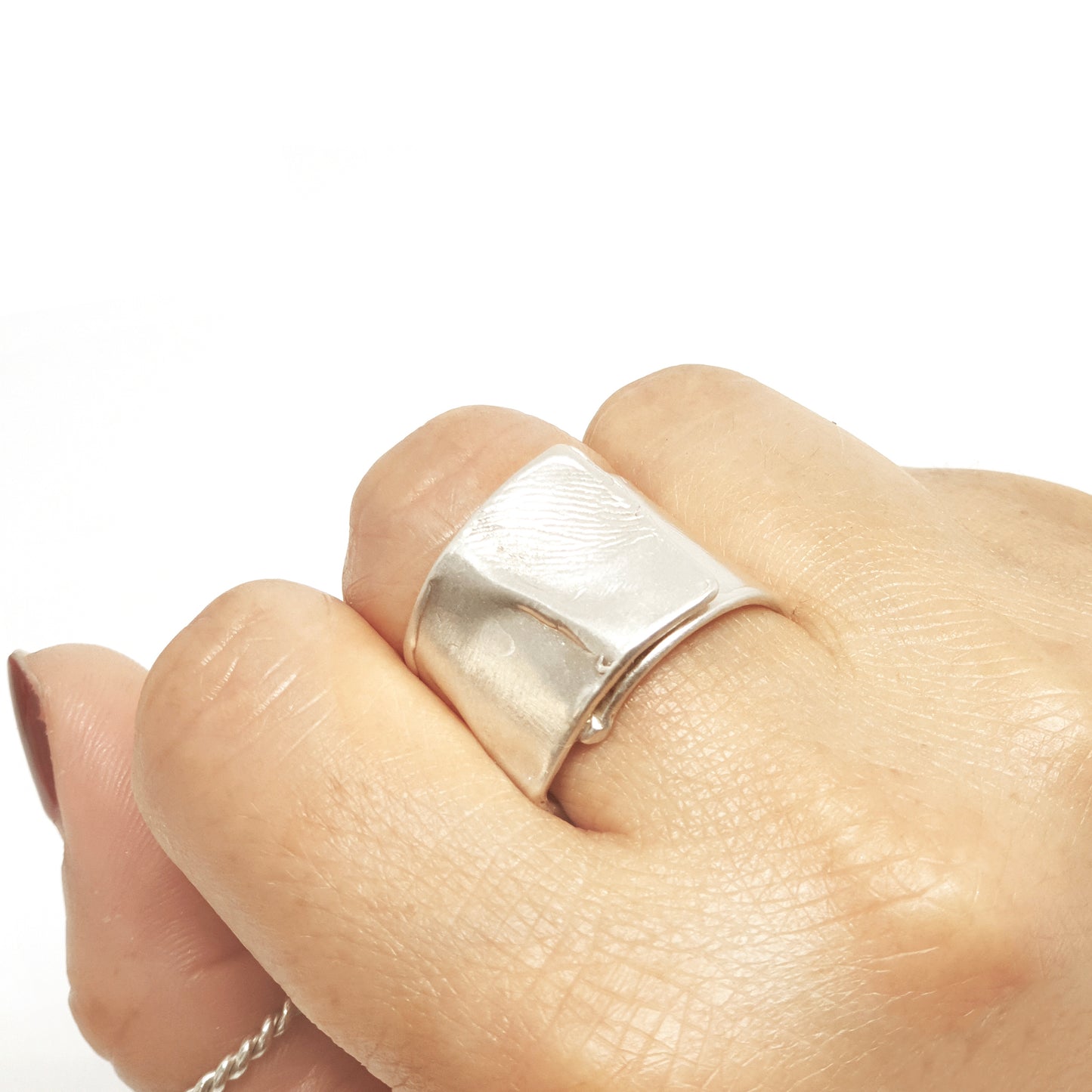 The Sterling Silver Spirel Ring by FR | Art Jewellery features a wide, oxidised band with a wavy textured surface and a visible fingerprint, giving this handcrafted piece an organic, one-of-a-kind look.