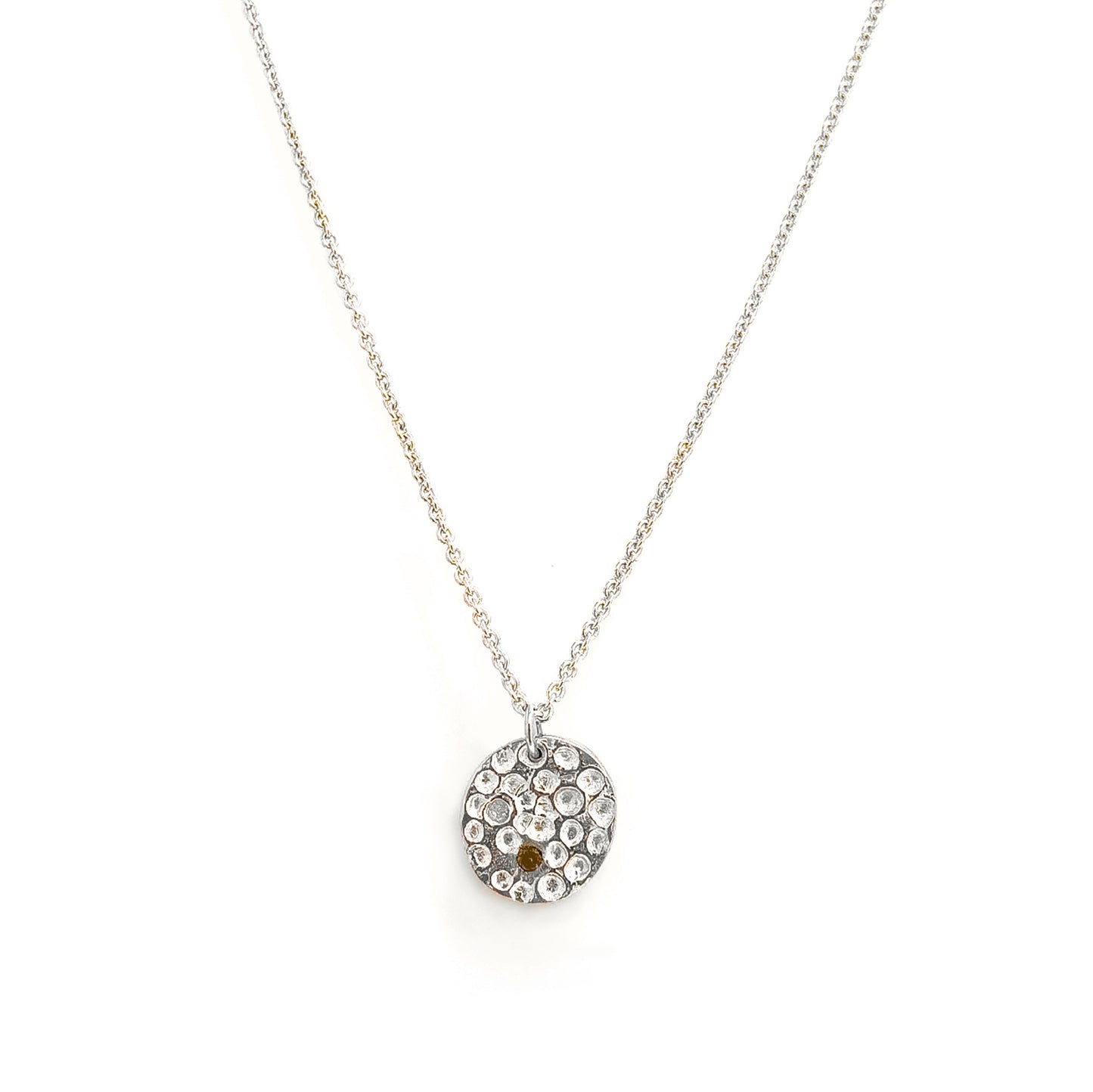 The Spot of Light necklace by FR | Art Jewellery features a sterling silver chain with a round pendant set with clear stones and a single citrine, showcased on a white background.