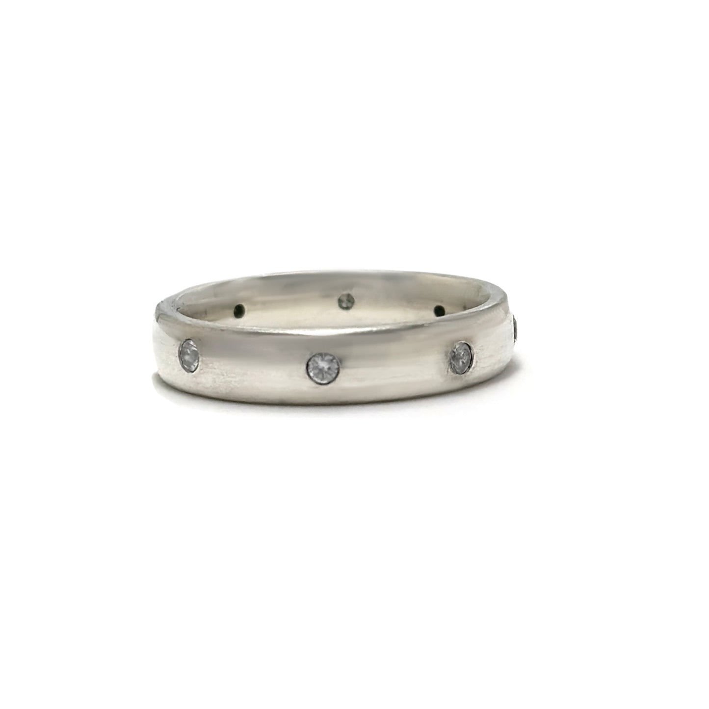 The FR | Art Jewellery Sterling Silver Diamond Band Ring features multiple small white diamonds evenly spaced around the sleek silver band, shown on a white background.