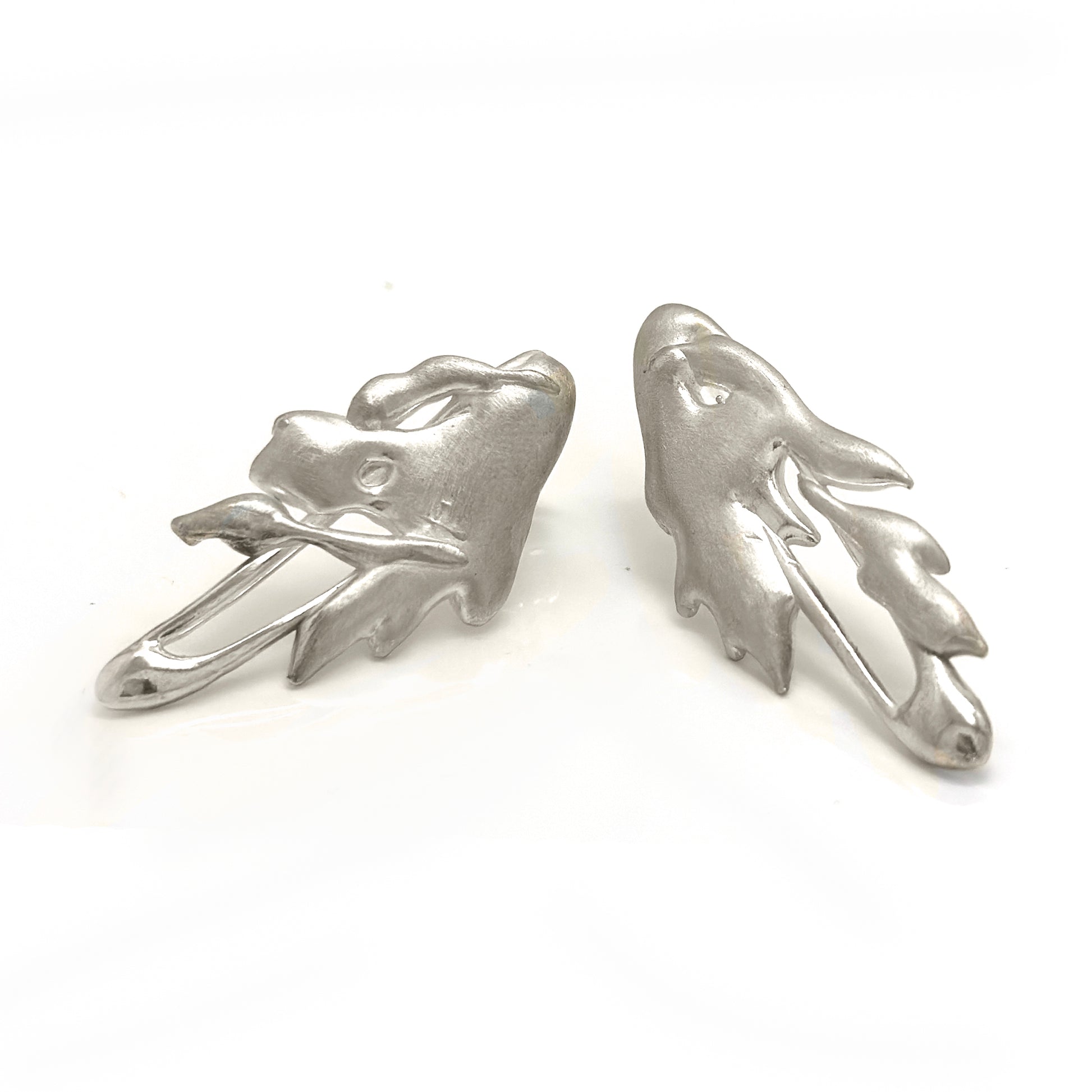 The Symbio Earrings – Gold Plated in Sterling Silver by FR | Art Jewellery feature an abstract wavy, leaf-like design and are handmade wearable art, showcased elegantly against a white background.