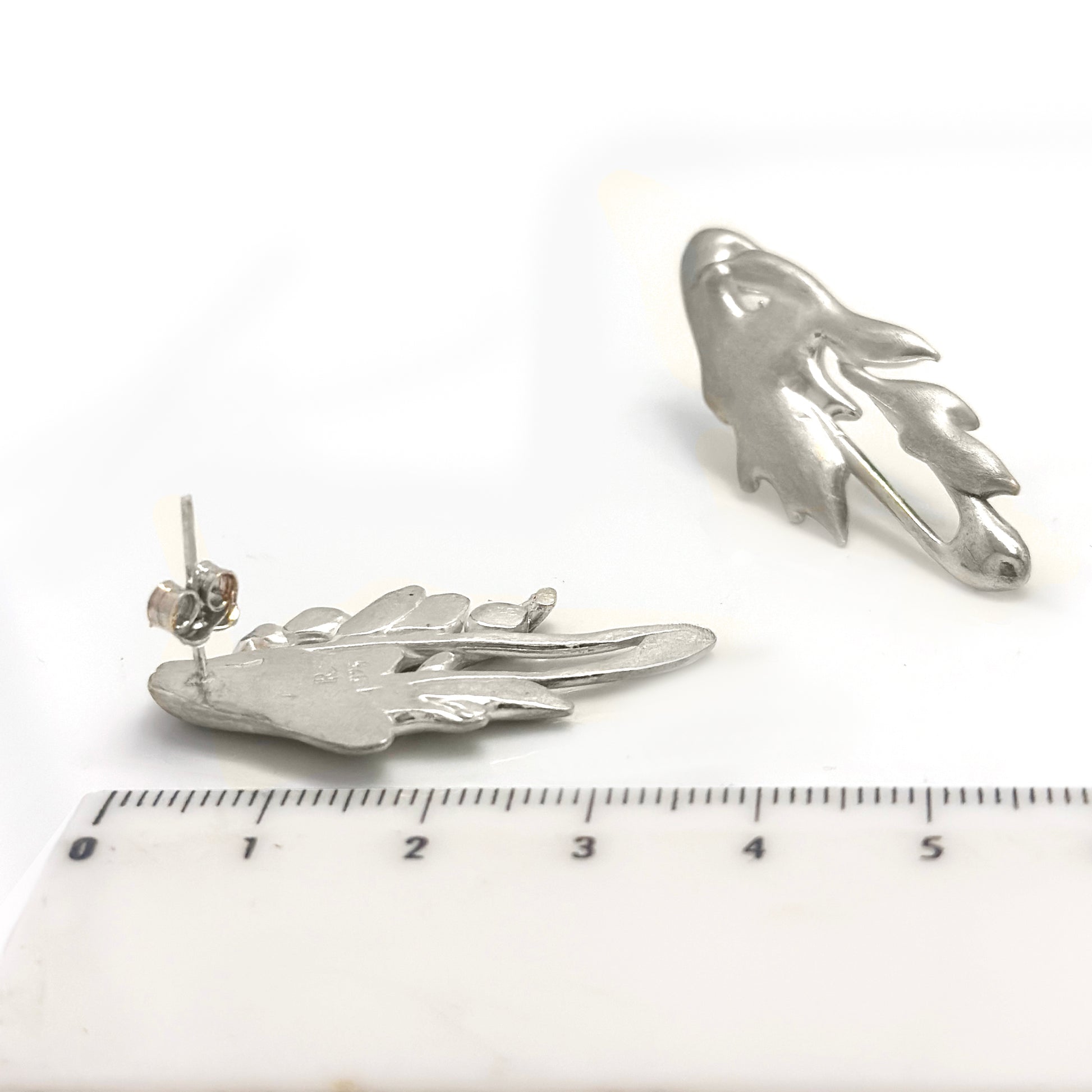 The Symbio Earrings – Gold Plated in Sterling Silver by FR | Art Jewellery feature an abstract wavy, leaf-like design and are handmade wearable art, showcased elegantly against a white background.