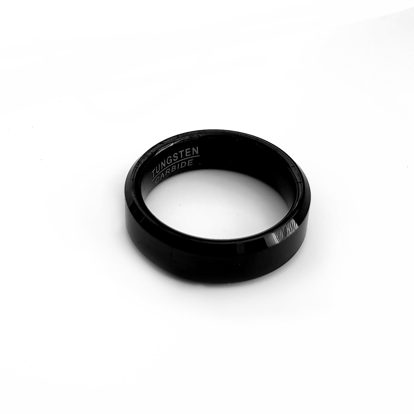 The FR | Art Jewellery Tungsten Black Bezel ring features a smooth, shiny finish and a comfort-fit design, showcased against a white background.