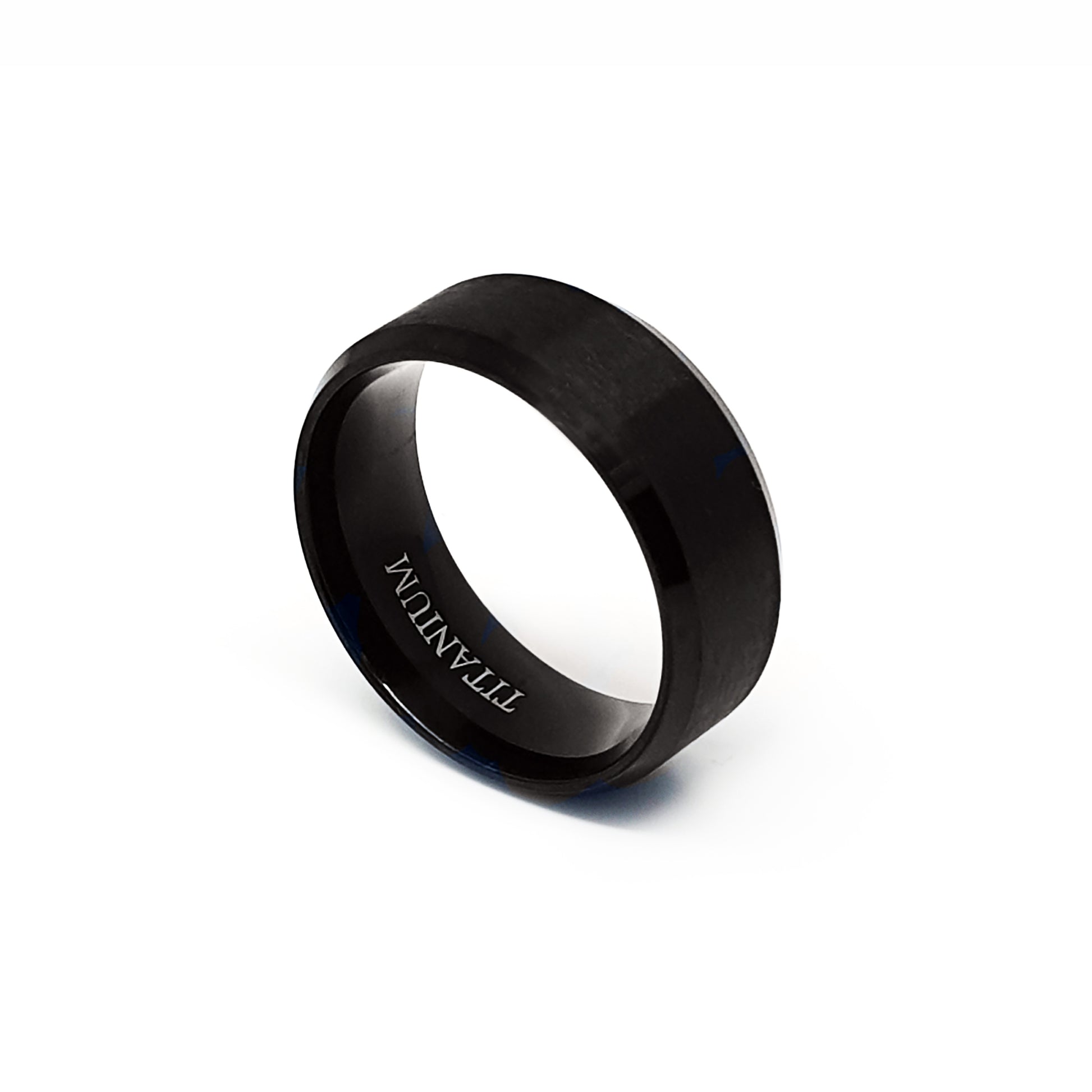 The Titanium Black Bezel Ring by FR | Art Jewellery is displayed on a white background. This comfort-fit band features a smooth black matte finish and "TITANIUM" engraved on its inner surface.