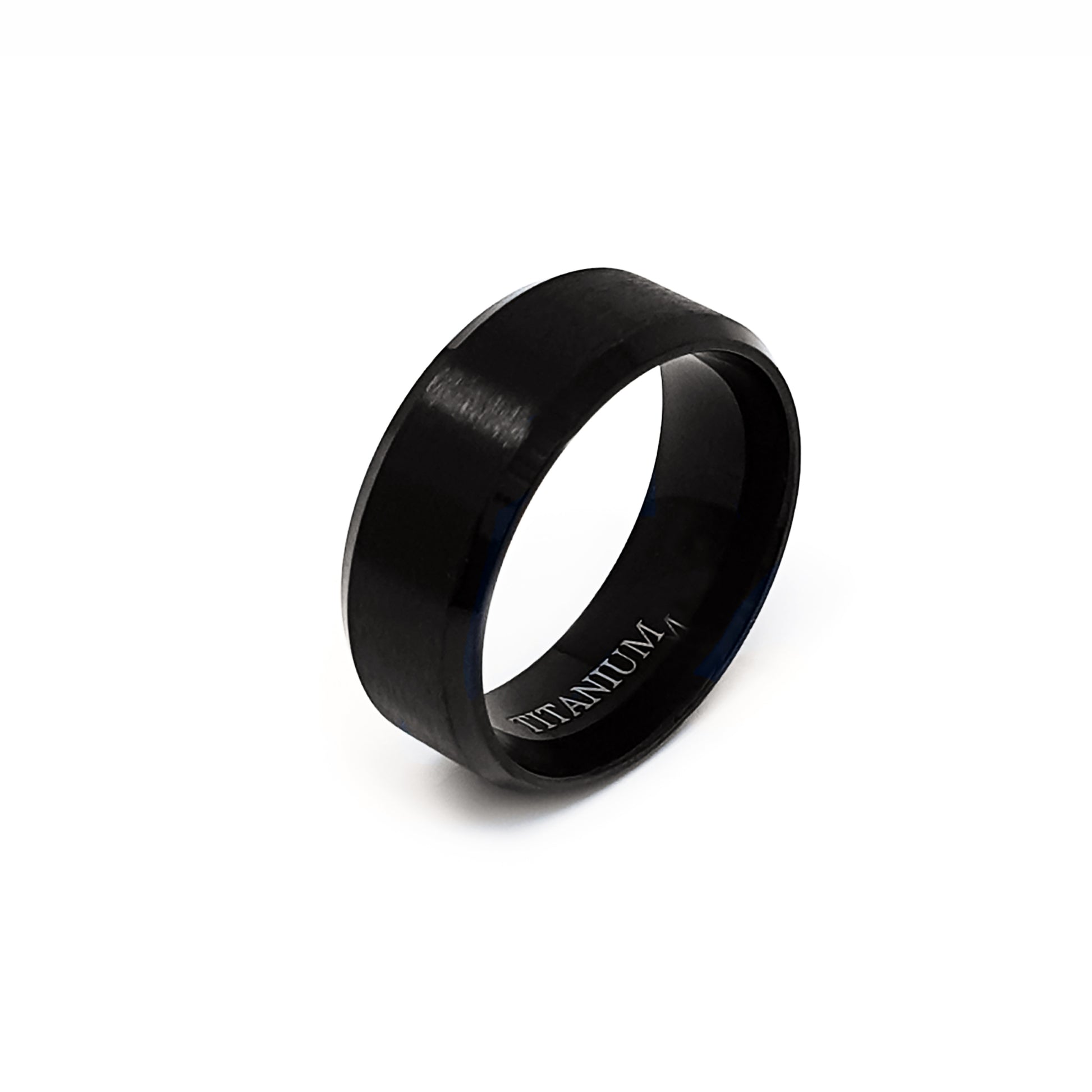 The Titanium Black Bezel Ring by FR | Art Jewellery is displayed on a white background. This comfort-fit band features a smooth black matte finish and "TITANIUM" engraved on its inner surface.