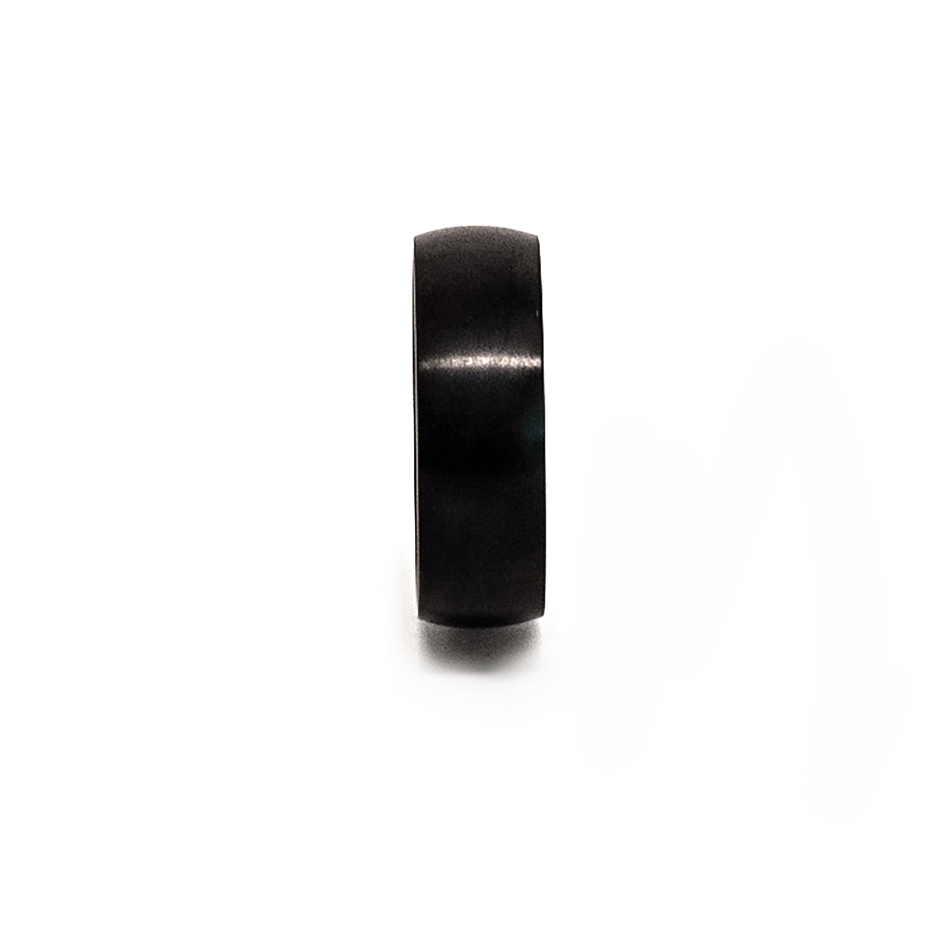 The Titanium Black Ring by FR | Art Jewellery is a comfort-fit titanium band with a black matte finish, shown upright on a white background and engraved with "TITANIUM" inside.