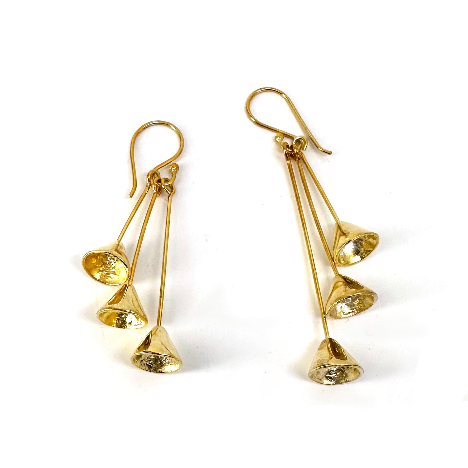 Check out the "Three Cones" earrings from FR | Art Jewellery, featuring three dangling cone-shaped pendants on each gold-plated piece, attached to hooks. These handmade jewellery items boast a metallic shine that reflects light beautifully, offering a stunning appearance.