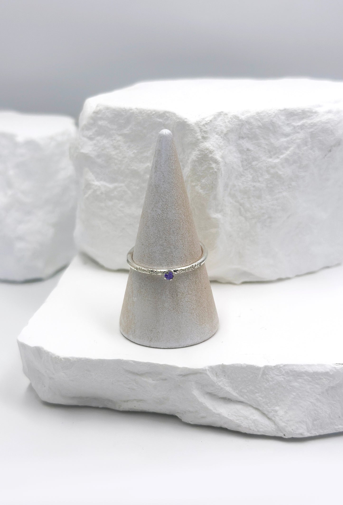 The Tinytoo Sterling Silver twisted Ring with Amethyst Gemstone by FR | Art Jewellery features a minimalist design—perfect for everyday elegance and beautifully displayed on a white background.