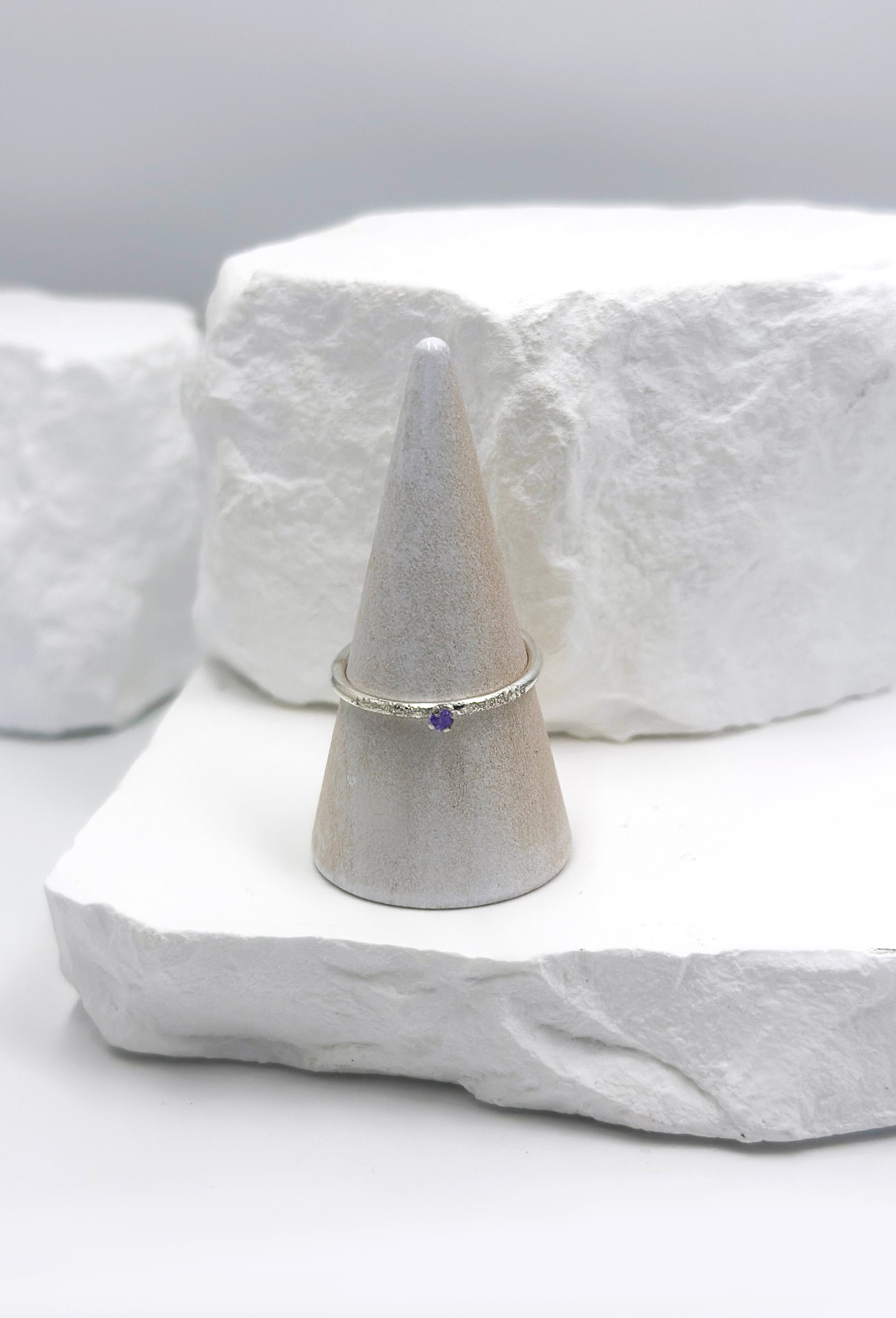 The Tinytoo Sterling Silver twisted Ring with Amethyst Gemstone by FR | Art Jewellery features a minimalist design—perfect for everyday elegance and beautifully displayed on a white background.