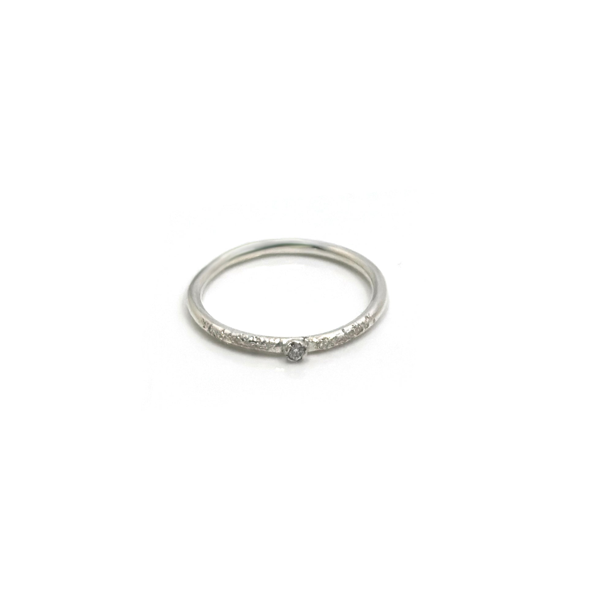 The Tinytoo Sterling Silver Ring with Diamond Gemstone by FR | Art Jewellery features a small central diamond and tiny diamonds on the band, shown against a plain white background.