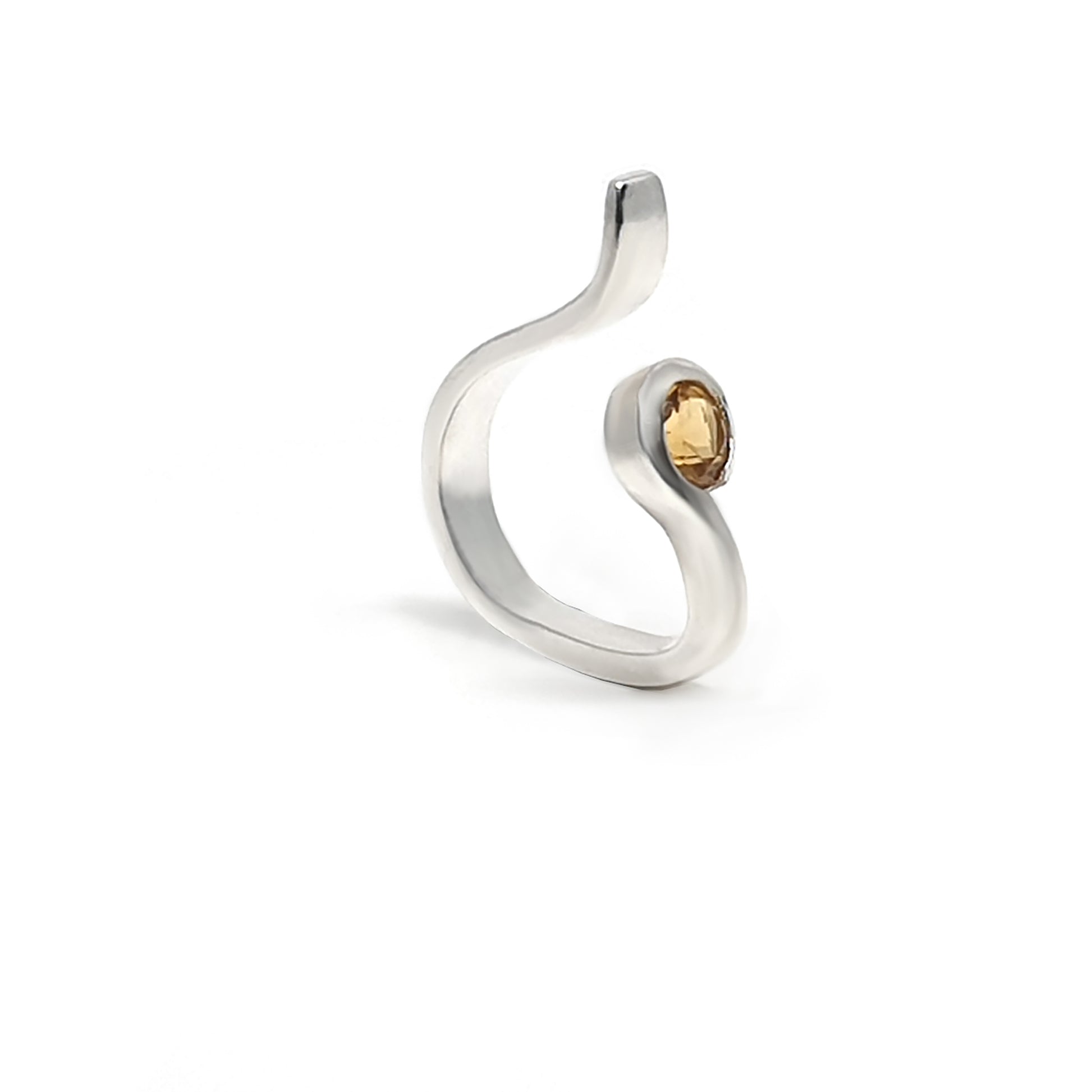 Introducing the Touch Ring by FR | Art Jewellery: a silver, snake-like ring featuring a single yellow gemstone. This piece boasts an open design, with one end raised and the yellow stone embedded near the other end, creating a minimalist and elegant look. Part of our Handmade Jewellery collection, this exquisite ring is showcased against a plain white background.