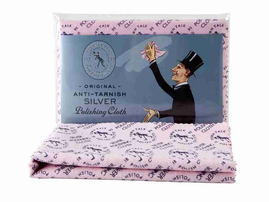 A pink anti-tarnish polishing cloth branded as "FR | Art Jewellery," labeled with pattern text "HS101" and "Polishing Cloth." The packaging displays an illustration of a man in a suit and top hat cleaning silverware, with the text "Anti-Tarnish Silver Polishing Cloth" above him. This product, named Silver Polishing Cloth - Town Talk, is ideal for jewellery care and maintaining silver shine.