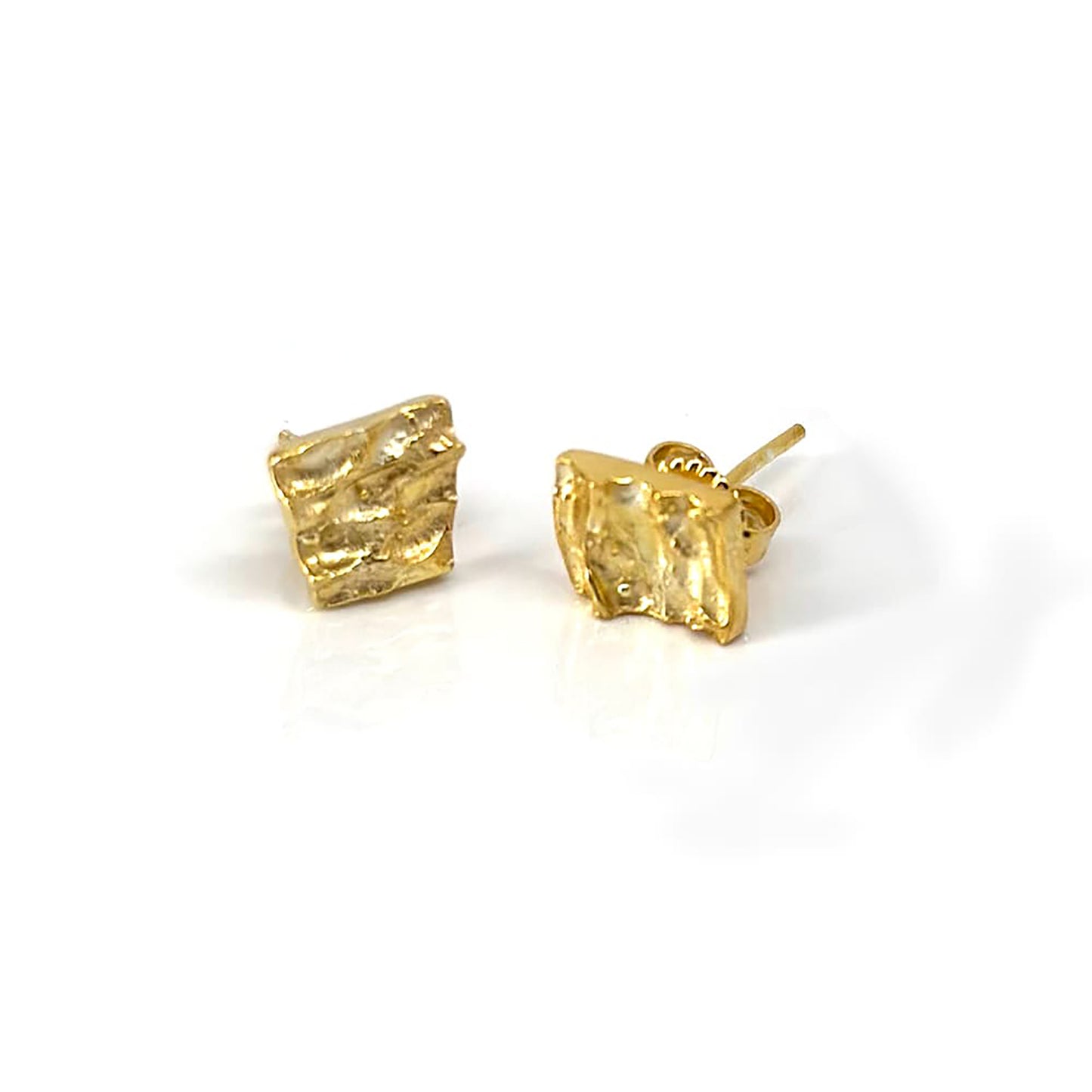 The Tribu Earrings by FR | Art Jewellery are displayed against a white background. These small, square-shaped gold-plated earrings feature a textured, wavy surface and come with standard post and butterfly backings, exemplifying exquisite handmade jewellery.