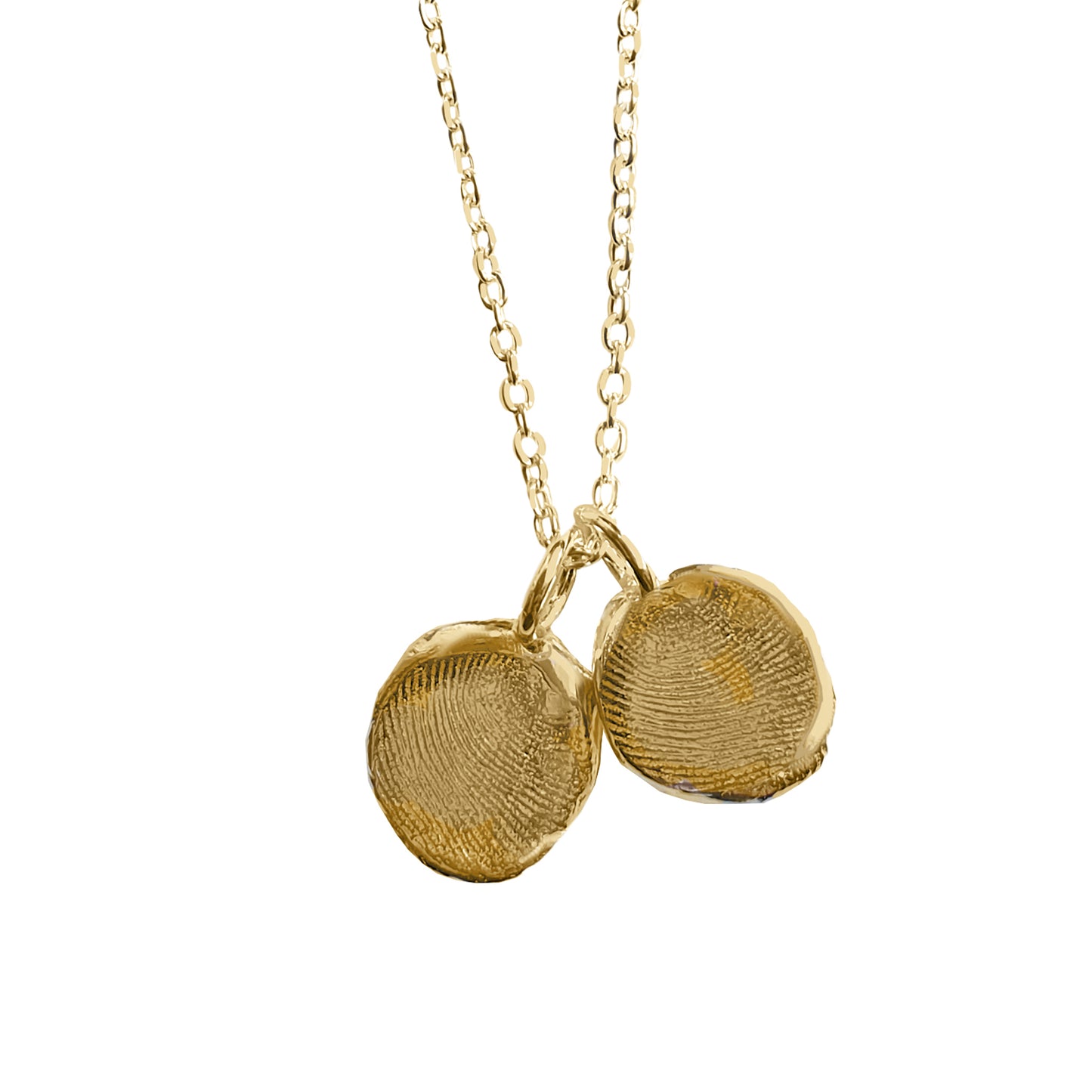 Introducing the Fingerprint Necklace by FR | Art Jewellery—a gold chain link design adorned with two round pendants, each uniquely imprinted with custom fingerprint designs. The pendants hang closely together, creating Custom Impressions for a personalized and elegant accessory. Displayed on a plain white background, this necklace beautifully emphasizes the intricate details of the fingerprint textures.