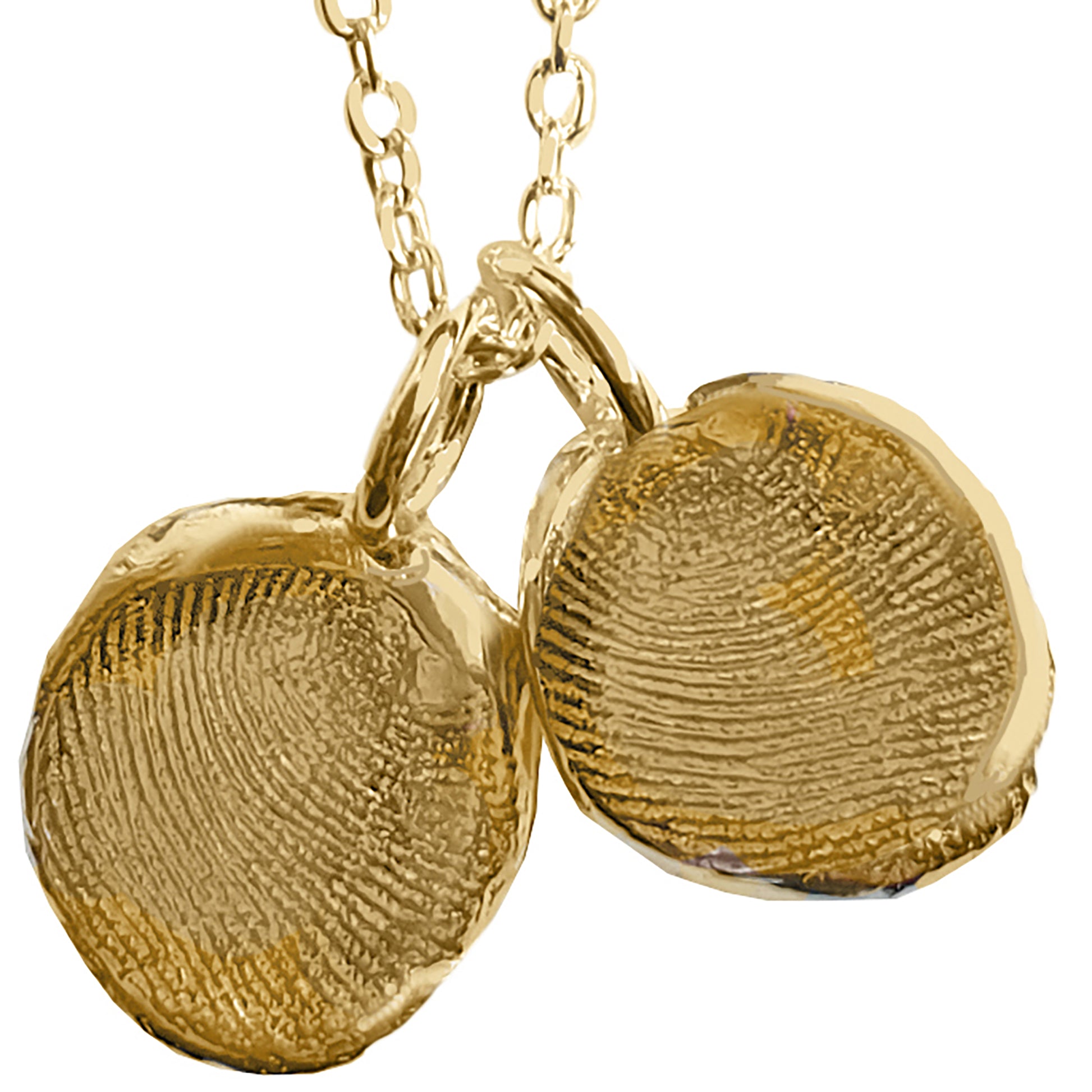 Introducing the Fingerprint Necklace by FR | Art Jewellery—a gold chain link design adorned with two round pendants, each uniquely imprinted with custom fingerprint designs. The pendants hang closely together, creating Custom Impressions for a personalized and elegant accessory. Displayed on a plain white background, this necklace beautifully emphasizes the intricate details of the fingerprint textures.