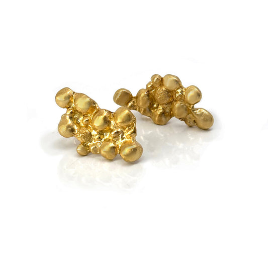 A pair of irregularly-shaped, gold-plated nugget earrings with a bumpy, textured surface on a white background. The earrings have a shiny, polished finish and resemble natural gold formations. Perfect for those who appreciate handmade jewellery's unique charm from FR | Art Jewellery's Pearl Earrings.