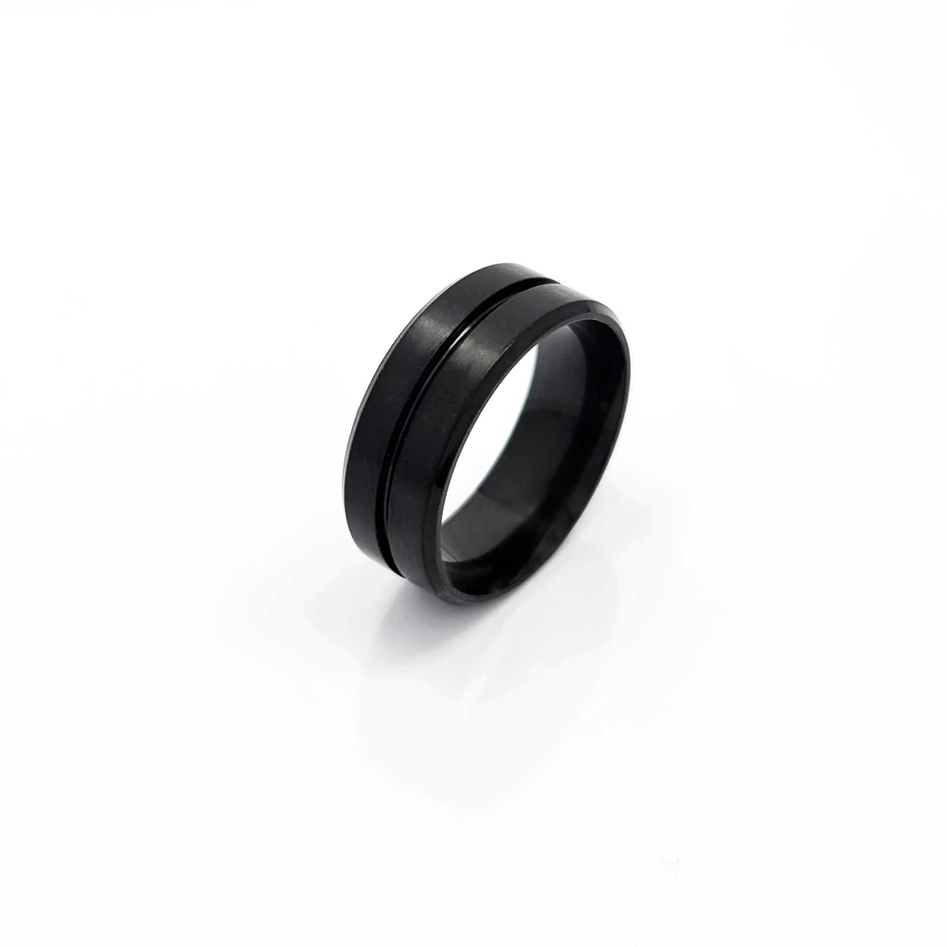 The Stainless Steel Middle Groove ring by FR | Art Jewellery features a black matte satin polished finish, a subtle center groove, and a comfort-fit design, shown on a white background.