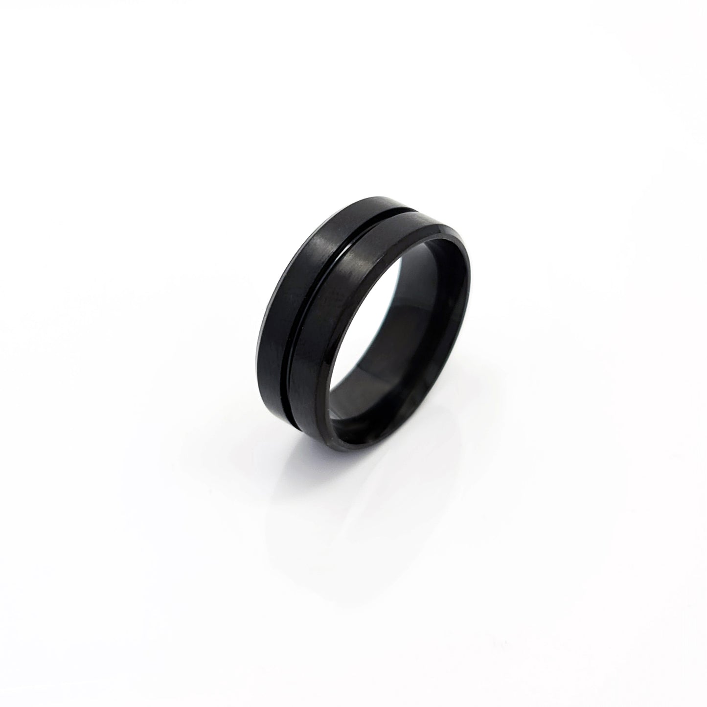 The FR | Art Jewellery Stainless Steel Line Middle ring is a contemporary matte black wedding band with a sleek single groove, showcased on a plain white background.